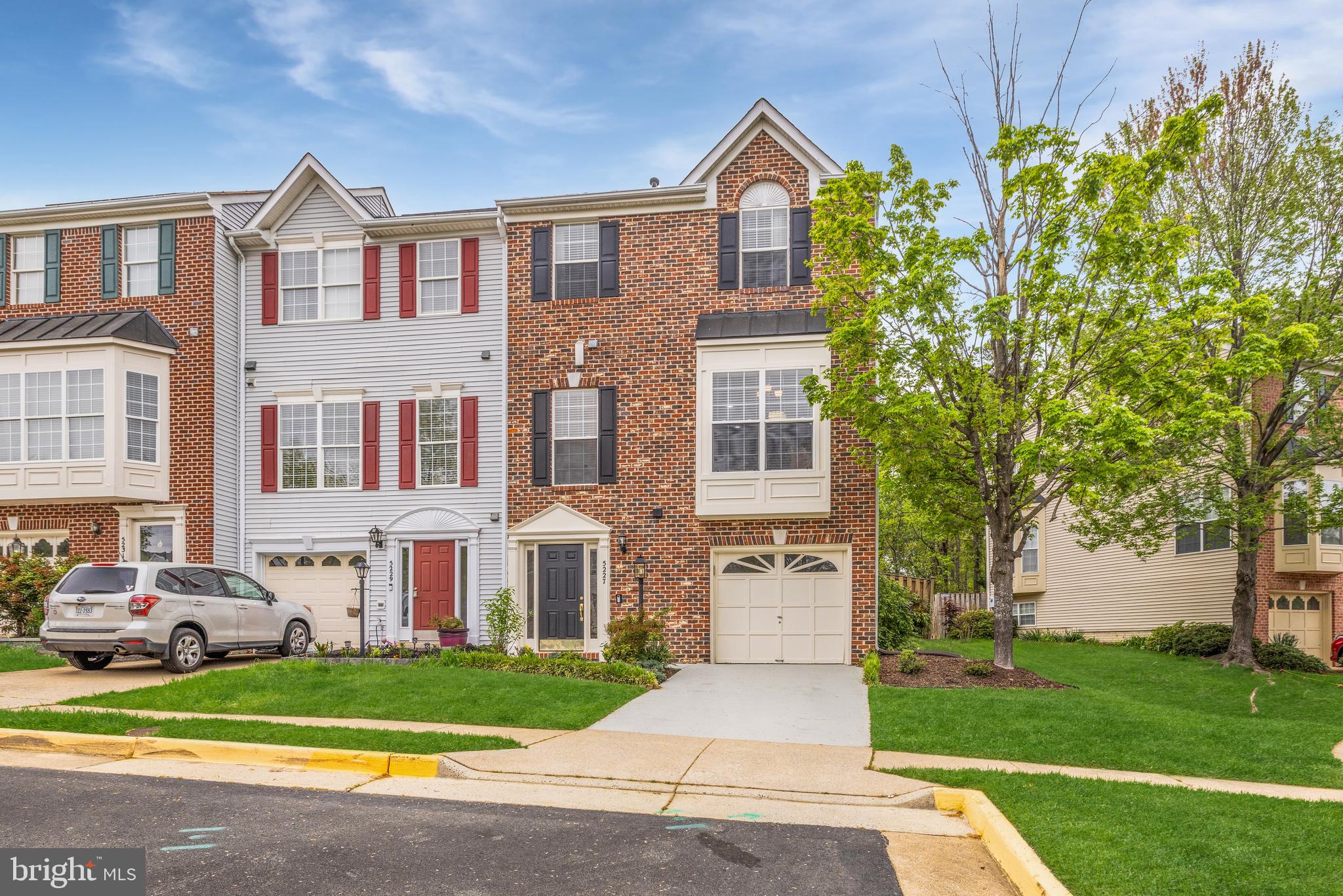 Welcome to 5227 Ballycastle Circle, a fabulous brick-front end-unit Westcott model backing to trees on a quiet street in Alexandria’s popular Kingstowne. This home is bright and cheerful with all the light streaming in from three sides and features a box-bay window in the breakfast room and a classic bay window in the dining room. You’ll also appreciate the many modern light fixtures throughout. There are dazzling wide-plank floors on the main level. The impressive eat-in kitchen has rich cabinetry, stainless appliances, sleek granite countertops with an overhang for bar stool seating, recessed lighting and a useful pass-through to the living room. Chair rail, crown molding and a classy chandelier give the separate dining room a feeling of elegance.  The living room also has crown molding plus recessed lights and a gas fireplace with a detailed wood mantel. Step out through double doors to the awesome deck refinished in 2023 overlooking trees - perfect for that indoor/outdoor lifestyle! Upstairs, there are three bedrooms and 2 full baths. The owner’s suite has a soaring vaulted ceiling and walk-in closet with organizers (custom design was new in 2023) plus an en-suite bath with a two-sink vanity, jetted deep-soaking tub and separate shower. The well-lit lower level features the rec room with the second fireplace, a powder room and walks up to the fully-fenced rear yard. The furnace and sump pump were replaced in 2025, the water heater was new in 2024 and the roof and skylight window were new in 2020. This beautiful home comes with the endless list of Kingstowne amenities - pools, gyms, community centers, sport courts, tot lots, 12 miles of walking trails and more! It’s also close to two Metro stops, two town centers and all commuter routes!