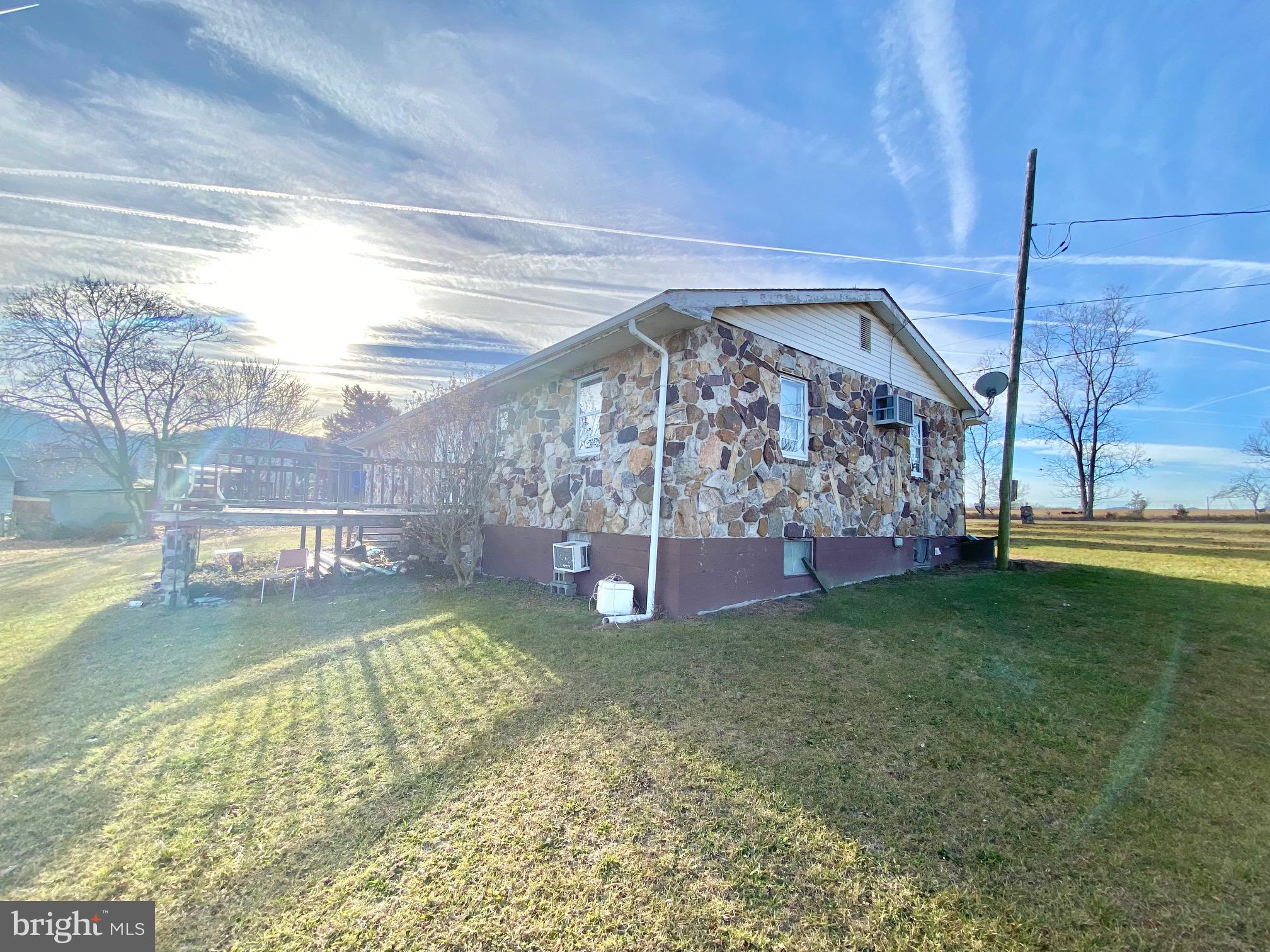 Located close to Petersburg and Corridor H, this 3 bedroom, 1 bath Rock Rancher is perched on a double lot with long range mountain views.  This home also boasts 2 basement bedrooms, living room, second kitchen area and a half bath that could be easily converted into a full bath. The second lot features a large two car detached garage and plenty of yard area.  Perfect starter home with a total of 5 bedrooms in case you have lots of youngins.  Priced to Sell, Call Now For Your Own Private Tour!!