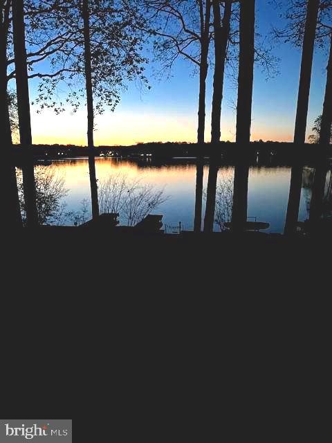 Imagine waking up every morning to the gentle whispers of the lake and the golden glow of breathtaking sunrises that fill your heart with peace. This isn’t just a house; it’s a sanctuary where every corner tells a story of love, care, and thoughtful upgrades that enhance the stunning lake views you’ll cherish forever.

Nestled on a generous 25,000sf lot, picture yourself unwinding on the new, spacious screened porch and deck with Timbertech Aztec flooring & elegant wire railings. Step through the new triple French doors and feel the seamless flow to this screened porch and deck or take the side back stairs to the new door.  This all crafted for your ease and enjoyment. You’ll feel the soft breeze and a wide-open view across the beautiful lake.    Under deck water drainage system, cedar ceiling & deck posts  add to the beauty of this outdoor space.  The warmth of the sun is felt with a serene beach just a few steps away inviting you to relax and reconnect with nature. An outdoor shower offers a refreshing escape after a day on the lake!  
The addition of the charming concrete, slate & stone front porch with radiant floors greets you with warmth as you enter the custom front door.  You will experience a grand entrance that frames the stunning lake views like a masterpiece. Foyer was redesigned to a larger entrance space just made for a reading nook.  Shiny new hardwood floors in family room with gas fireplace leads you to an open-floor plan, the large island with granite counter & kitchen with new gas stove. Lage sliding glass doors & a large picture window were added to enhance the view from inside & exit to the screened porch. 

Outside this lovingly renovated home also boasts a brand-new Timbertech Aztec dock, perfectly designed with new footers, ramp, and bulkhead, plus a U-shaped dock ready to welcome your boats and endless adventures on the water. Garage was transformed to a front entrance, adding new concrete floor, exterior drainage pad, mid-century modern garage doors, Pella windows & man door to front patio as well as new garage door openers.  Exterior brick painted to enhance the beauty of the new design & windows.

Efficiency meets beauty — from the wrap-around deck added (where there was only a stoop) to the modern ceiling fans and lighting, the inviting TV hookups, all-new Pella windows, updated soffits, gutters, and pest-proof attic vents. The lower-level recreation/game room opens to a concrete patio through two added sliding doors, inviting laughter and memories. Additional thoughtful improvements include a new culvert pipe & asphalt driveway with enhanced drainage.  A welcoming sidewalk leads to the lower patio — all designed to make life easier and more beautiful.

With 3,990sf of lovingly maintained indoor space and extensive outdoor renovations, this home is more than a place to live-- it’s where your heart will find its home. Every detail inside and out reflects a commitment to comfort and style.  Don’t miss the chance to embrace the ultimate waterfront lifestyle and create memories that will last a lifetime.
