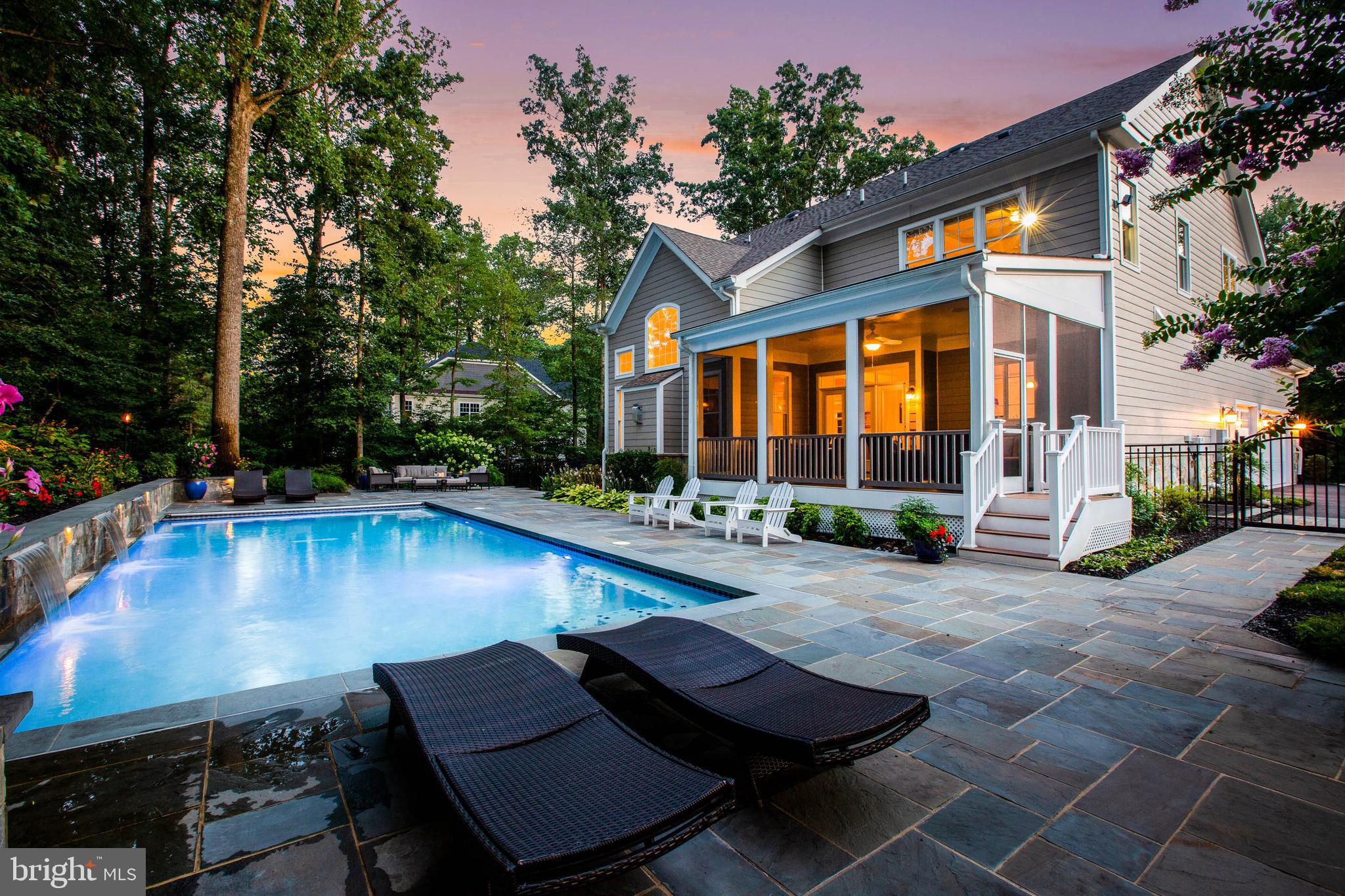 Tour this Property from the comfort of your laptop, cell phone, or better yet: in Virtual Reality! - Click on the virtual tour for a 3D walk-thru! Custom Home captures the Essence of Today's Living.  From the striking architectural stone facade to the meticulous craftsmanship, this warm and welcoming home exudes endless grace blended with modern conveniences. The abundance of open living spaces on all three levels is magnified by high ceilings, natural light, luxurious finishes and impeccable details. True Chef's Kitchen is designed and equipped to inspire any culinary endeavor. Refresh every sun-filled day and moon-lit evening delighting in the resort-style back yard; pool with waterfalls, screen porch, extensive patios & decking and privacy fencing all on a .92 acre lot hugged by trees. Resplendent Master Suite is a sanctuary full of quiet pleasures where one will want to retreat nightly. Lower Level is simply fun with a pub-style bar, sound-proof theater, fitness area and bedroom suite. Desirable Oakton convenience to all Northern Virginia points and beyond!