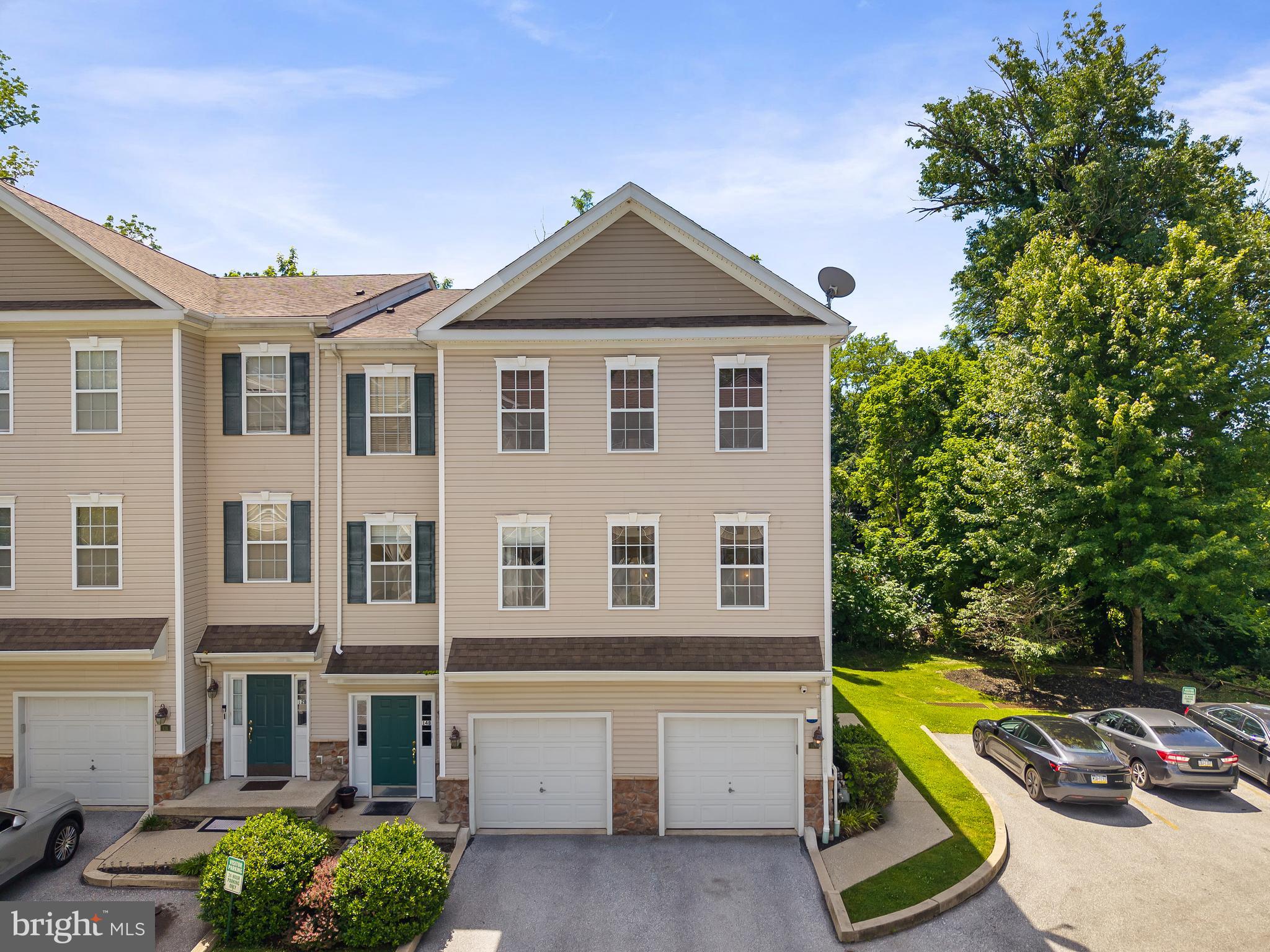 Perfectly positioned on a premium end-unit lot, this beautifully updated townhome combines modern finishes, low-maintenance living, and one of the best locations within the community. 

Since its last purchase, the home has been thoughtfully updated, including all-new flooring throughout, creating a fresh, modern feel from top to bottom. The flexible lower level features an attached garage with interior access, a full bathroom, and a spacious family room that can easily serve as a guest suite, home office, gym, or additional bedroom. Sliding doors provide direct access to the rear patio, perfect for relaxing or entertaining.

The main level is designed for today's lifestyle with an open-concept floor plan centered around a beautifully appointed kitchen featuring modern cabinetry, updated appliances, ceramic tile backsplash, center island with sink, and breakfast bar seating. The kitchen seamlessly overlooks the dining and living areas, creating an ideal space for everyday living and gatherings alike. Step outside onto the rear balcony and enjoy peaceful views that set this home apart from the rest.

Upstairs, you'll find two generously sized bedrooms, a full hall bath, and a spacious primary suite complete with two walk-in closets and a luxurious en-suite bath featuring double vanities, a soaking tub, and separate shower.

Additional highlights include recessed lighting, custom blinds, six-panel doors, a dedicated laundry and utility room, security cameras, and a one-year home warranty.

Conveniently located within walking distance of downtown Lansdowne's restaurants, shops, and the popular farmers market, as well as the SEPTA Regional Rail station, this home offers the perfect blend of low-maintenance living, modern updates, and commuter convenience. A rare opportunity to own one of the community's premier end-unit locations—schedule your showing today!