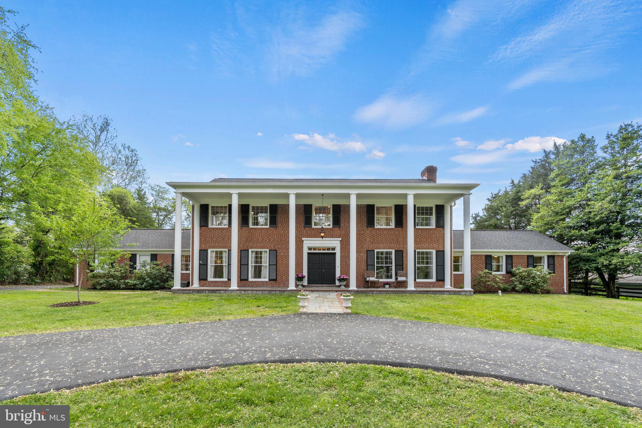 Nestled within a two-acre parklike setting, this classic 4 bedroom plus bonus room, 5-full bath center hall colonial checks every box for the buyer seeking gracious primary and private living space, work-from-home options and every amenity for enjoying the outdoors. The freshly painted interior is enhanced with newly refinished hardwood flooring, three woodburning fireplaces, and beautifully updated baths.  Formal living and dining rooms are ideal for entertaining, and the family room features an oversized fireplace, built-in cabinetry, and an expansive picture window.  The spacious kitchen adjoins a renovated breakfast/gathering room overlooking the magnificent rear grounds, where a pool, barn and four seasons of thoughtfully curated landscaping create a pastoral, storybook setting.  Designed for the leisurely lifestyle that this home offers, there is a full guest/pool bath on the main level and a large mudroom and laundry accessed by the two-car garage.  The home offers primary suites on both the main and upper level.  Tucked away privately from the day-to-day living areas, the spacious main level primary suite enjoys a beautiful bath and walk-in closets.  Upstairs there are three large bedrooms; one that includes a luxurious designer ensuite bath with an oversized curb-less shower and dual vanities. Each bedroom has ample space for furnishings and wardrobes.  Ascend the stairs to the attic level and the expansive finished space which presents so much flexibility for use: a wonderful child’s playroom; a private home office…even an artist’s studio.  The walk-up lower level has a full kitchen with granite countertops and stainless steel appliances, brand new luxury vinyl flooring throughout, a large recreation room with wood-burning fireplace and a sizeable bonus room and updated bath. Step outside to a wonderful and private paradise, where a pool invites laps and languishing on a warm day, a large lawn expanse is the perfect ballfield, fruit trees to enjoy freshly picked peaches and pears, and a barn adds the finishing touch to this quintessential town-and-country home.  From the newly paved circular driveway to the inviting resurfaced pool, this property offers turn-key living within a setting of unrivaled natural beauty. This perfect oasis is located in the top-rated Wootton High School district and minutes to shopping, restaurants and major commuter routes. **Tax record square footage does not include breakfast and bathroom addition or finished attic.**