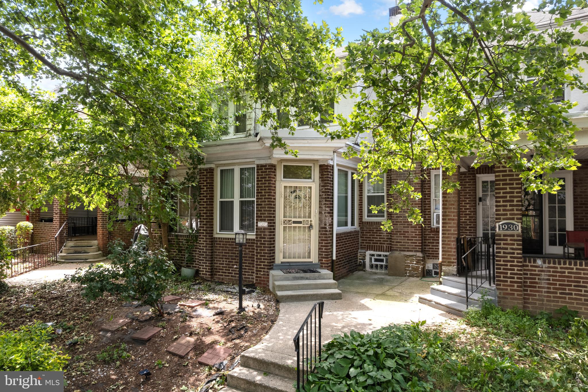 Welcome to 1928 W. Godfrey Avenue, a classic 3-bedroom, 1.5 - bathroom brick rowhome packed with character, natural light, and incredible potential. Located on a lovely, quiet street in the heart of Philadelphia's 19141 zip code, this home features a seamless layout just waiting for your personal style.
Pass through the indoor front porch—an ideal spot for a sunny reading nook—into a spacious living and dining area boasting original hardwood floors and large windows. The classic eat-in kitchen offers plenty of workspace and steps directly out to your private backyard. Upstairs, you’ll find three generously sized, sun-drenched bedrooms and a full three-piece bathroom. The lower level includes a finished basement for extra living space, plus the ultimate city luxury: an attached rear garage and driveway for dedicated parking. While the home requires some cosmetic updates, it is the perfect canvas to build immediate equity. Schedule your tour today and imagine the possibilities!