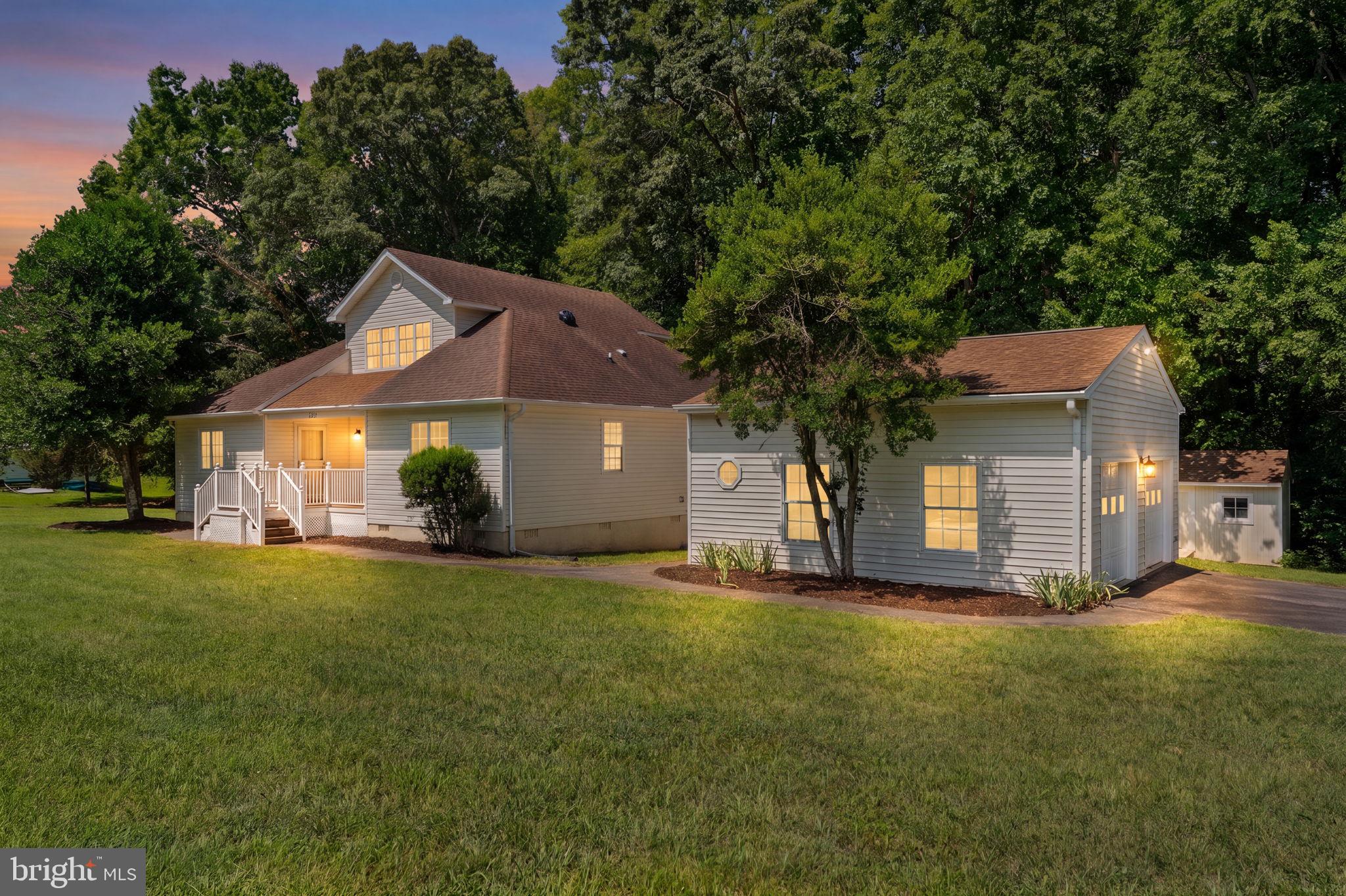 Charming and completely renovated water-access home on the public side of Lake Anna, offering the perfect combination of land, lake access, and location. Situated on a gorgeous corner lot of nearly one acre that backs to mature trees, this beautifully updated home offers over 2,000 square feet of comfortable living space with four bedrooms, two full bathrooms, and an oversized detached two-car garage.

Inside, you'll find vaulted ceilings, some hardwood flooring, fresh paint, new luxury vinyl plank flooring, new carpet, and a beautifully renovated kitchen featuring granite countertops and stainless steel appliances. The spacious primary suite offers a walk-in closet and private en suite bathroom.

The upper level features a spacious loft-style bonus area, providing the perfect flex space for a home office, reading nook, playroom, fitness area, or second family room.

Step outside to enjoy the newly updated front porch with composite decking and the expansive rear deck with new wood decking, creating the perfect space for entertaining, relaxing, or enjoying the peaceful wooded backdrop.

Located in a gated community on the public side of Lake Anna, residents enjoy exceptional amenities including multiple common areas, sandy beaches, boat ramps, boat slips, a fishing pier, and more. Just minutes from restaurants, grocery stores, breweries, wineries, and all that Lake Anna has to offer. Short-term rentals are permitted, making this an outstanding opportunity as a full-time residence, weekend getaway, or income-producing investment property.

(Some photos have virtual staging, furniture & furnishings)