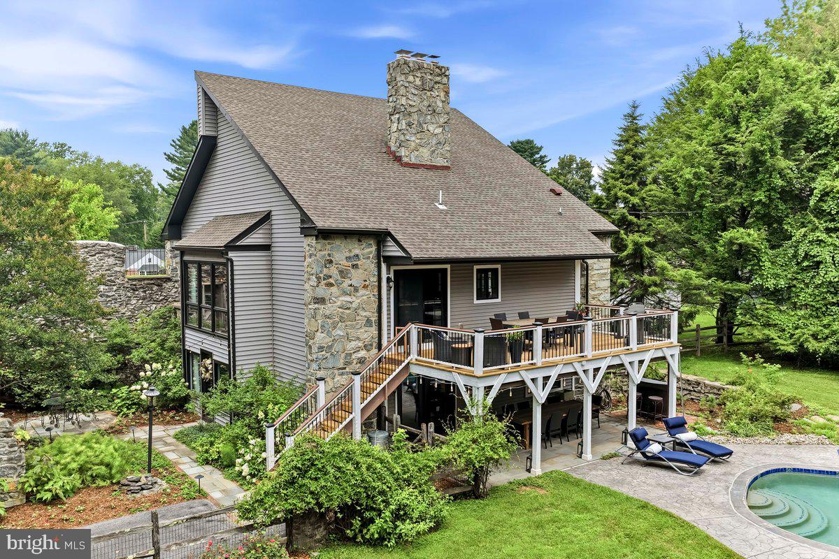Welcome to "Ivystone", a Magnificent and Stunning Converted Bank Barn situated on a Beautiful Acre, with an In-Ground Pool, and separate Carriage House that is a Two Car Garage with a first floor Fitness Room, and a second floor Studio Office. This Unique and Completely Renovated Home was built in 1827, and is walking distance into Downtown West Chester for the Restaurants and Shopping experience with the best Beverage Establishments in Chester County. This Gorgeous Masterpiece sits far from the road and has a true private oasis with the recently upgraded pool with pebble decking. The Historic Bank Barn features include the original stone arches and enclosed court yard and brick walk way leading to the main entrance. There's also a stone covered fire pit area, flagstone patio, and a large deck with new deck boards overlooking the private vista like back yard and pool area. The lower level main entrance features a Large and Charming Foyer, a Tavern and Recreation Room, an In-Law or Multi Generational Suite with a Full Kitchen, Living Room with a stone and gas fireplace and bar, a Beautiful Bedroom with a Gorgeous newer Bathroom, and door to the covered rear flagstone patio and yard and pool area. Level Two with real Hickory Hardwood Flooring features a Large Living Room with a stone and gas fireplace, Casual Dining Room, and a newer Gourmet Kitchen with quartz counters, farm house sink, 6 burner gas range and griddle, coffee nook, and two beverage fridges. The Designer Powder Room is newer, and the Primary Bedroom is on this level with two walk in closets with built-ins, motorized window shades and the newer Primary Bathroom with a laundry closet. Level Three features Two more Bedrooms with dramatic high ceilings and sun windows, large closets, and an updated Hall Bathroom with double stone sinks. There's also a large walk in hall closet on this level, and gleaming hardwood floors.  This Unique and Stunning property is one of those rare opportunities to own and experience an 1800's Stone Bank Barn Residence of Yesteryear, but with all of the Modern Amenities of Today. The location is so convenient to everything, and with only minutes to Downtown West Chester, this becomes the Best of Both Worlds for a Private Living Experience, but only a short distance to the Dining and Beverage Excitement of the Borough. Welcome to where Charm and Character meets Designer and Modern Features, with the Bonus In-Ground Pool, Bonus Carriage House Garage with Fitness Gym and Studio Office, an additional storage shed, Original Bank Barn Stone Features including the Court Yard and Stone Covered fire pit area, and the Private Back Yard Oasis with fencing to keep in your pets. The owners tied into the public sewer in 2019. This one is a keeper and guarantees Many Years of Happy Memories.