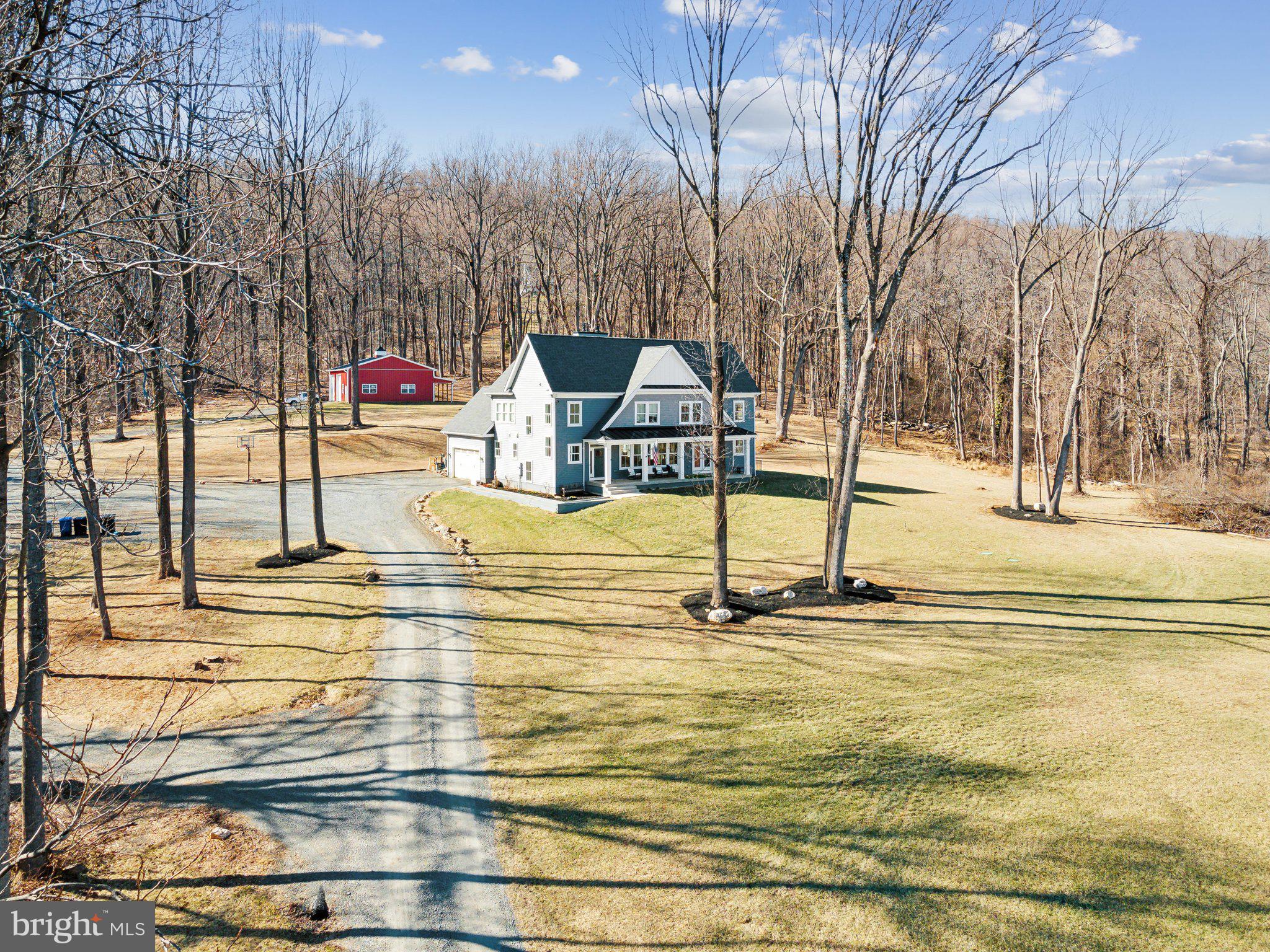 Here is your opportunity to own a beautiful piece of property in Western Loudoun County. Custom built in 2019, this stunning home is like new with spectacular Eastern mountain views. Sitting on 8 mostly wooded acres, privacy abounds. The main level features a very open layout with a gorgeous stone floor to ceiling fireplace and full bathroom with stand up shower. There is a main level private office/sunroom off the kitchen, a large laundry/mud room and a wall of windows to appreciate the mountain views. The upper level features four spacious bedrooms with walk in closets. Solid oak hardwood floors and 9' ceilings throughout. The lower level is ready to be finished with egress for a fifth bedroom, rough-in plumbing for a full bathroom and walk out stairs to the side yard. The exterior features a large 36' x 48' detached garage workshop, private deck and gazebo. There is also plenty of cleared space in the front and back for outdoor lawn activities, animals or a pool! Enjoy walkability to local brewery and winery.