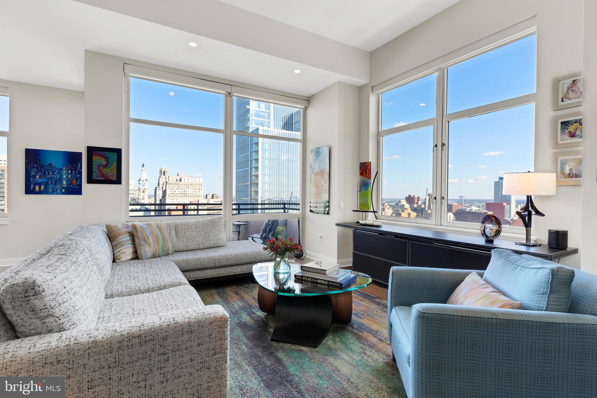 Exquisite- adj. magnificent, rare, dramatic, beautiful.  Suite 2903 at famed Symphony House is indeed stunningly exquisite.  A luxurious 2,147 square feet, this three bedroom, 3.5 bath residence enjoys its
commanding perch at the northeast corner of the soaring 29th floor of prestigious Symphony House.  A dynamic and breathtakingly compelling 270 degree panoramic is the living, breathing artwork and inspired backdrop for the flat.  Quite simply, mesmerizing.  This rare corner residence boasts expansive live space and a smart open-concept, modern floor plan.  A twelve-foot ceiling enhances the feeling of airiness and breadth of space. Gorgeous wide-plank hardwood floors, electric shades, elegant custom lighting, and oversized windows framing the vibrant cityscape.  The main live space is comfortable and sophisticated.  This expanded layout allows for a formal dine space adjacent, or an extension of
living room square footage, both perfect for entertaining.  The urban galley kitchen is a masterpiece, and a newer renovation.  The contrast of striking dark stone countertop to custom white cabinetry is a
harmonious blending, complemented by stainless JennAir professional appliances and a modern glass-tile backsplash.  This focal space and heart of the home boasts plentiful storage and a convenient walk-in
pantry.  Aligning the kitchen, a sleek line of modern built-in and display shelving with this striking stone counter. Adjacent and flanked by floor to ceiling glass, the  breakfast room/dining space is beautifully enhanced by custom built-in shelving for bar/coffee bar or display, with additional storage.  Step outside to a private open-air balcony for a morning cappuccino or dinner under the stars, the city sights
and sounds of the Avenue of the Arts, a beautifully orchestrated serenade all around you.  Tucked away and a peaceful haven, the primary suite is spacious and bright, complemented by an expansive custom walk-in and two additional closets with linen.  The spa-like bath, a newer renovation, features an oversized seated walk-in shower, dual sink, stone countertops, and a built-in vanity with plentiful storage.
Opposite the residence, two unique, spectacular guest suites with unrivaled views that will catch your breath.  The first suite floats in the sky as if on air, overlooking the Avenue, with incredible City
Hall and river vistas.  A spacious custom walk-in closet and lovely en-suite bath complete this very special guest quarters.  The second suite boasts an incomparable and very rare eastern-facing triple
window, capturing phenomenal sunrises, and a 180 degree expanse of leafy green trees and shimmering river/bridge panoramic.   Bright and beautiful, with plentiful closets and en-suite bath. Either unique suite provides amazing versatility and easily doubles as a stunning home office or den.   A convenient full-sized laundry room with extra storage, and a chic hall half bath complete this gorgeous residence.  Suite 2903 is a rare gem. Boasting the optimal floor plan for ease of living and privacy, Suite 2903 elevates the sophisticated urban living experience.  See it today.  Two garage spaces and a spacious storage locker are included with the residence.  Offering unparalleled services and amenities, prestigious Symphony House is the city's premier Avenue of the Arts address boasting 24/7 concierge and doorman, 65' heated indoor lap pool, steam and sauna, state-of-the-art fitness center, bike share, beautiful outdoor terraces, Library, Clubroom, dining salons, wine cellar and Chef's catering facility. Stellar location, ideally situated amid the city's vibrant theatre district, steps from the finest restaurants, boutique shopping and all the city has to offer! Center City Philadelphia will forever remain proudly resilient and a hallmark destination, and Symphony House continues to enjoy its well-earned status as one of the most prestigious buildings in the city.  The brightest star on the Avenue.