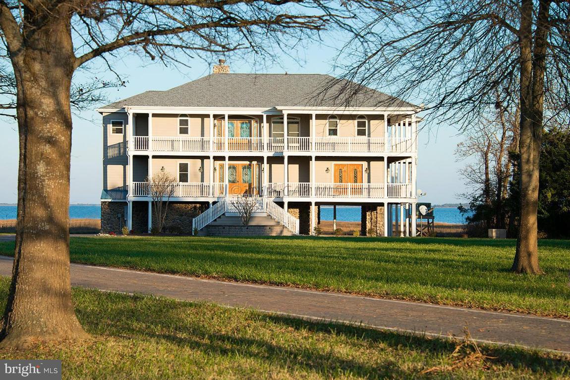 Pictures are prior to tenant moving in the house. Boat lift is excluded from the sale belongs to tenant.  Home needs some repairs. Direct Bay Front Estate 4BR/3.5BA overlooking Assateague Island. If you want a relaxing lifestyle with panoramic breathtaking Bay views look no further. As you enter your new estate you will drive up a 379 foot custom paver driveway and pull into your oversize garage. You could then take the elevator, or use the stairs, and gaze out onto your 1.9 acre property with its 450ft lighted pier and two boat slips. This custom home was built with the finest craftsmanship. The elevated first floor has three large bedrooms, two bathrooms, a family room for entertaining, and a custom tiled room complete with a shower designed specially for washing your pets. There is a beautiful wood staircase that winds to the second floor, where you will find an additional spacious family room with wood burning fireplace perfect for year round enjoyment.  The chef in your family will love the large custom gourmet kitchen with granite countertops and stainless steel appliances. Also on this floor is the master suite overlooking the Bay.  You will love watching the beautiful sunrises from almost every room in this house.  Enjoy relaxing on one of the many decks, outdoor dining and outdoor crab feasts. This is the perfect home and setting for you to enjoy for years to come and it's on 1.9 acres. It is minutes from Assateague Island and Ocean City and is in one of the Eastern shore's finest vacation destinations.   Pictures are prior to tenant moving in the house. Boat lift is excluded from the sale belongs to tenant.  Home needs some repairs.
