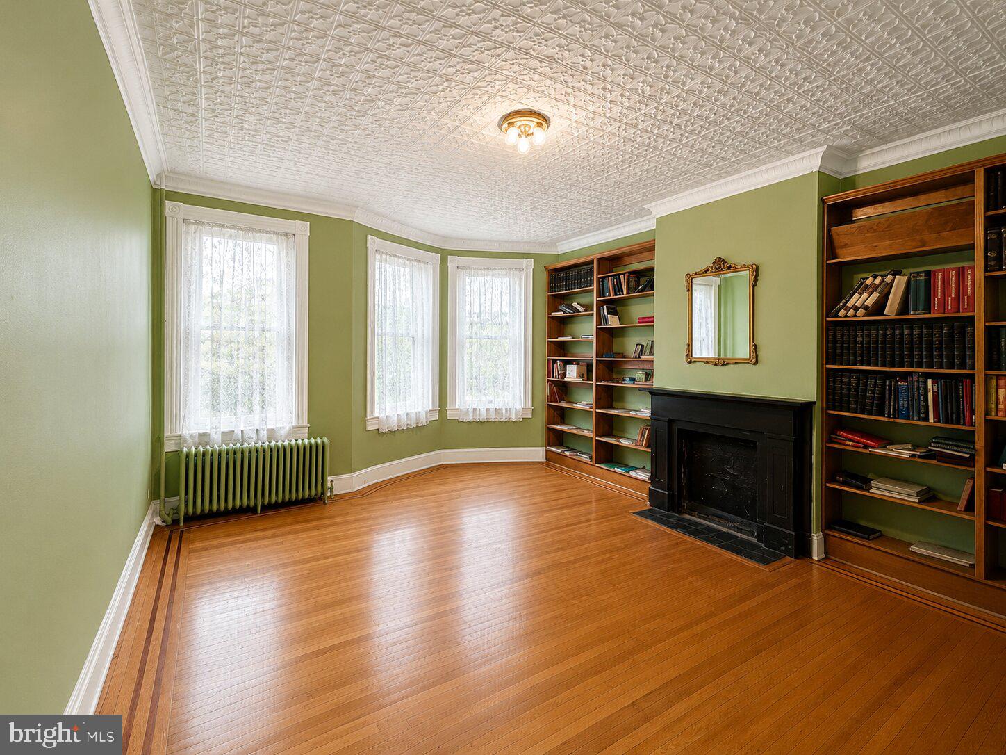 Historic brownstone located in Madison Park, offering significant upside and long-term equity potential. This large, character-rich property features 5 bedrooms and 4 baths (2 full, 2 half) and presents a true value-add renovation opportunity in a strong historic neighborhood with resale values reaching $700K+.
Architectural highlights include cathedral ceilings, original tin ceilings, glass transoms, inlay hardwood floors, pocket doors, chair rail, and detailed wall moldings throughout. The main kitchen features a center island, while the home also offers walk-in and walkthrough closets, dual vanity, ceiling fans, and skylights. The basement boasts high ceilings, two fireplace mantels, and an existing second kitchen, creating excellent potential for conversion to an in-law suite or auxiliary living space. The basement powder room is generously sized and can be converted into a full bath, adding additional flexibility and value. Radiator gas heat and a new roof provide strong foundational upgrades. Situated on a quiet cul-de-sac street across from the cathedral, this property offers a rare combination of historic charm, scale, and redevelopment potential in one of Baltimore’s most desirable historic neighborhoods. Ideal for homeowners who would a habitable equity opportunity or  investors seeking character, scale, and equity upside as well!