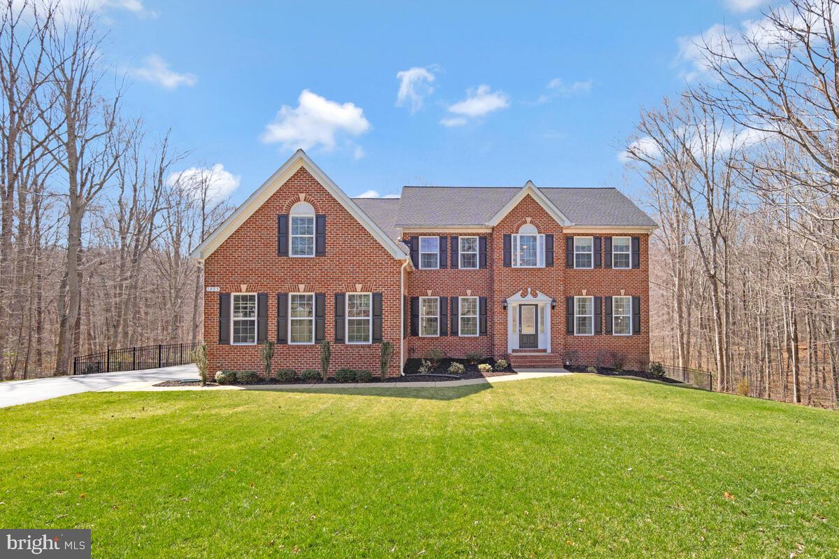 Stunning 5-BEDROOM 5,428 SQ FT upgraded home on a QUIET PRIVATE WOODED CUL-DE-SAC lot backed by TREES ON ALL SIDES in a premier community with 29 ESTATE LOTS of 1.5+ ACRES. RESORT-STYLE LIVING with IN-GROUND CUSTOM POOL, extended low-maintenance DECK, large PAVER PATIO, and 12x20 SHED/WORKSHOP with power. MATURE professionally maintained lawn with 14-STATION IRRIGATION SYSTEM. GRAND TWO-STORY FOYER opens to a GREAT ROOM with 20-FT CEILINGS and GAS FIREPLACE. DUAL STAIRCASE and 9-FT CEILINGS throughout. GOURMET KITCHEN features upgraded MAPLE CABINETRY, brushed nickel hardware, GRANITE COUNTERTOPS, GAS COOKTOP, DOUBLE WALL OVENS, stainless appliances, hardwood flooring, and OVERSIZED ISLAND. Formal DINING and LIVING ROOMS with CROWN MOLDING. 16x16 SUNROOM leads to the deck. HARDWOOD, TILE, and CARPET throughout. OVERSIZED MASTER SUITE with spa-like bath, DUAL SINKS, soaking tub, large WALK-IN SHOWER, WATER CLOSET, and a MASSIVE WALK-IN CLOSET extending the full length of the 3-CAR GARAGE. MAIN-LEVEL BEDROOM with adjacent FULL BATH. 1,800+ SQ FT FINISHED BASEMENT with high ceilings, full bath, and GYM. NEW CARPET & PAINT throughout (2026). CAT6 ETHERNET and HOME THEATER WIRED. NEW ROOF (2023) with GUTTER GUARDS. TANKLESS WATER HEATER. Extended DRIVEWAY resealed 2024. 3-CAR SIDE-ENTRY GARAGE with 3 DOORS and overhead storage. HOA-maintained 1.5-MILE WOODED WALKING TRAIL. NORTHERN CALVERT location with TOP SCHOOLS and easy commute to D.C., ANNAPOLIS, or PAX RIVER.
