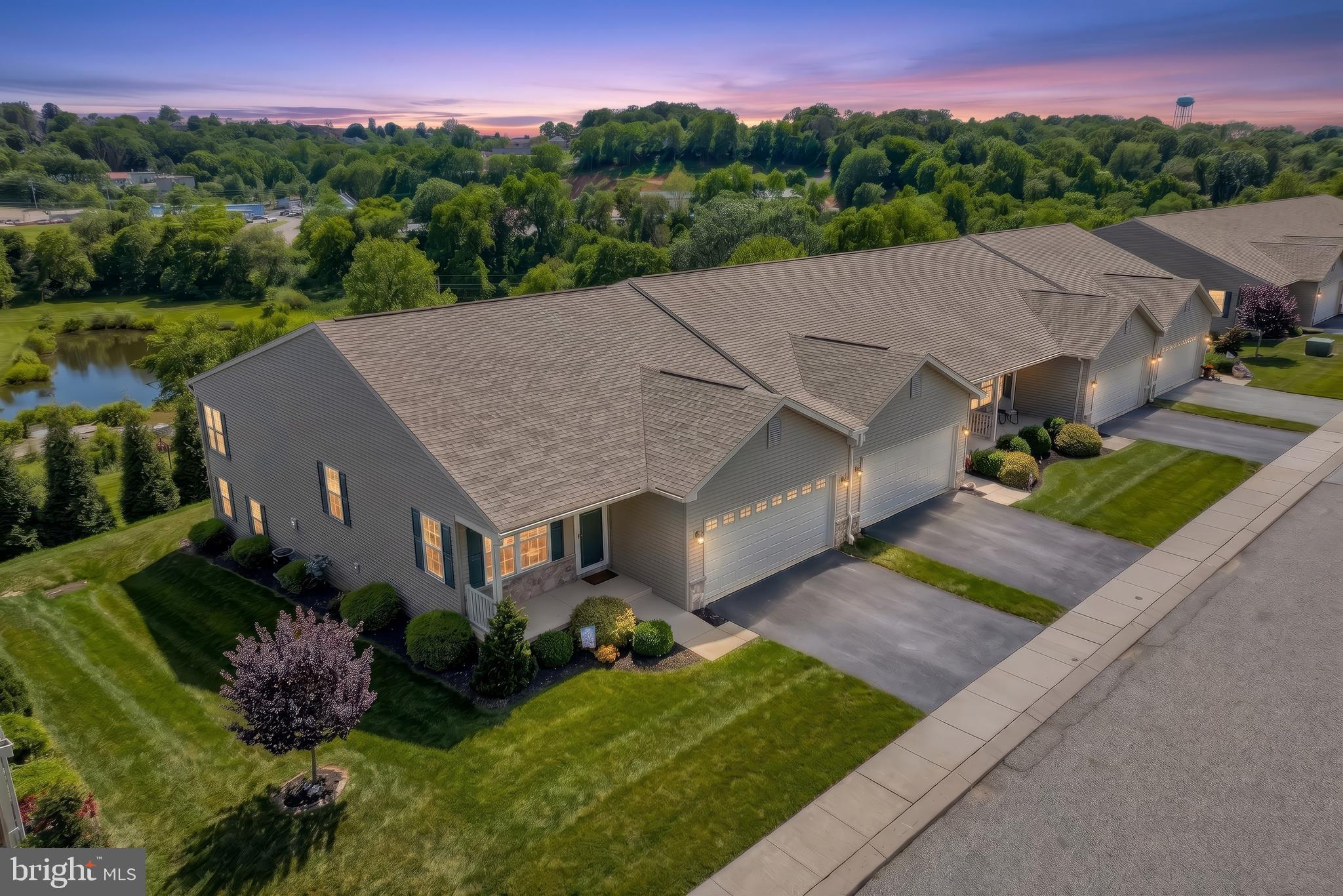 Welcome to carefree living at its finest in The Paddock of Equine Meadows, one of the areas most desirable 55+ communities. This spectacular end-unit condo is loaded with upgrades and impeccably maintained- there is truly nothing to do but back up your truck and move in. Step inside to discover an open and inviting main level featuring a spacious living room with soaring vaulted ceilings, ceiling fan and beautiful luxury vinyl plank flooring that flows into the dining area. The thoughtful designed kitchen offers granite counter tops, a breakfast bar, recessed lighting and an abundance of cabinetry for all your storage needs. Enjoy your morning coffee in the relaxing sunroom or unwind year-round in the stunning four-season room , added just 2 years ago , complete with vaulted ceilings, a ceiling fan, mini-split heating and air conditioning system and views of the outdoors. This condo offers 2 generously sized bedrooms and 3 full baths. The primary suite is a true retreat, highlighted by vaulted ceilings, blackout blinds, ceiling fan, a large walk in closet, and luxurious private bath featuring double sinks, and a walk-in shower with built in seating. The laundry room is located right off the garage as you enter the home.
The walk-out lower level expands your living space with a huge L shaped rec room, a full bath, workout area and an entire wall of storage closets. there is even a dedicated 220 line for installed for a future sauna. Step outside the lower level door and find a covered patio. The 2 car garage is equally impressive featuring a finished floor, laundry tub, pull down attic stairs and an electric vehicle charging station. 
If you have been searching for an exceptional home that combines comfort, style, convenience and low maintenance living, this condo is for you. Enjoy life and stop cutting grass, shoveling snow and doing outside yard work. Buyer to verify Square Footage