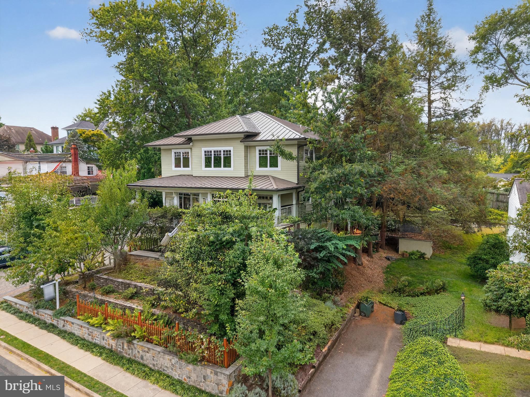 *Featured in “The Arlington Connection” and "Best Address" with Joe Himali!*

In the heart of Northern Virginia, where McLean, Arlington, and Falls Church meet, this extraordinary LEED Gold-certified custom home combines authentic Craftsman design with precision engineering to achieve unparalleled comfort, style, and energy efficiency.

Flooded with natural light from oversized windows,10ft ceilings on the main floor create expansive and inviting spaces, while warm wood accents, live edge built-ins, and artisanal stonework impart traditional Craftsman charm. The open-concept floorplan is perfect for relaxing or entertaining, allowing family, friends, and guests to enjoy the grand stone fireplace while creating gourmet meals in the thoughtfully designed kitchen, complete with custom maple cabinetry, soapstone countertops, and top-tier Energy Star and Bosch appliances. French doors open onto a secluded, organic landscape with a manicured lawn, elegant hardscaping, and an outdoor kitchen with a large countertop, built-in sink, and gas grill.

Every element of this home has been thoughtfully designed to optimize comfort and efficiency—from heated stone floors and custom window treatments, to high-quality built-ins and flexible closet configurations that maximize storage options. Upstairs, an expansive master suite enjoys a private, screened balcony and a stunning marble bathroom with separate shower, soaking tub, and wrap-around dual vanity. En suite bathrooms in three of the four other generously-sized bedrooms ensure that this home can grow with your family and offer plenty of options for guests. The fully-finished basement includes a 2-car drive-in garage, mudroom, workshop, and additional storage areas perfect for an exercise room and wine cellar.

A masterpiece of energy-efficient design, this LEED Gold-certified property boasts a two-zone, multi-stage geothermal heating and cooling system, on-demand European-style hot water heaters, and state-of-the-art sound-proofing and insulation technology to drive utility bills down to a bare minimum in the height of summer and dead of winter. With an energy-recovery ventilation (ERV) fresh air system, durable metal “solar-ready” roof, and rainwater catchment-fed landscaping irrigation, smart engineering seamlessly harnesses nature to maximize self-contained efficiency.

Located in the Fairfax County Public School District, this home feeds into Haycock Elementary School, Longfellow Middle School, and Mclean High School. Just over a mile from East Falls Church Metro and Rt. 66, it provides easy commuting options to both Washington, DC and bustling Tyson's Corner. 

Street power lines have been edited out of the listing photos to better display the home's facade.