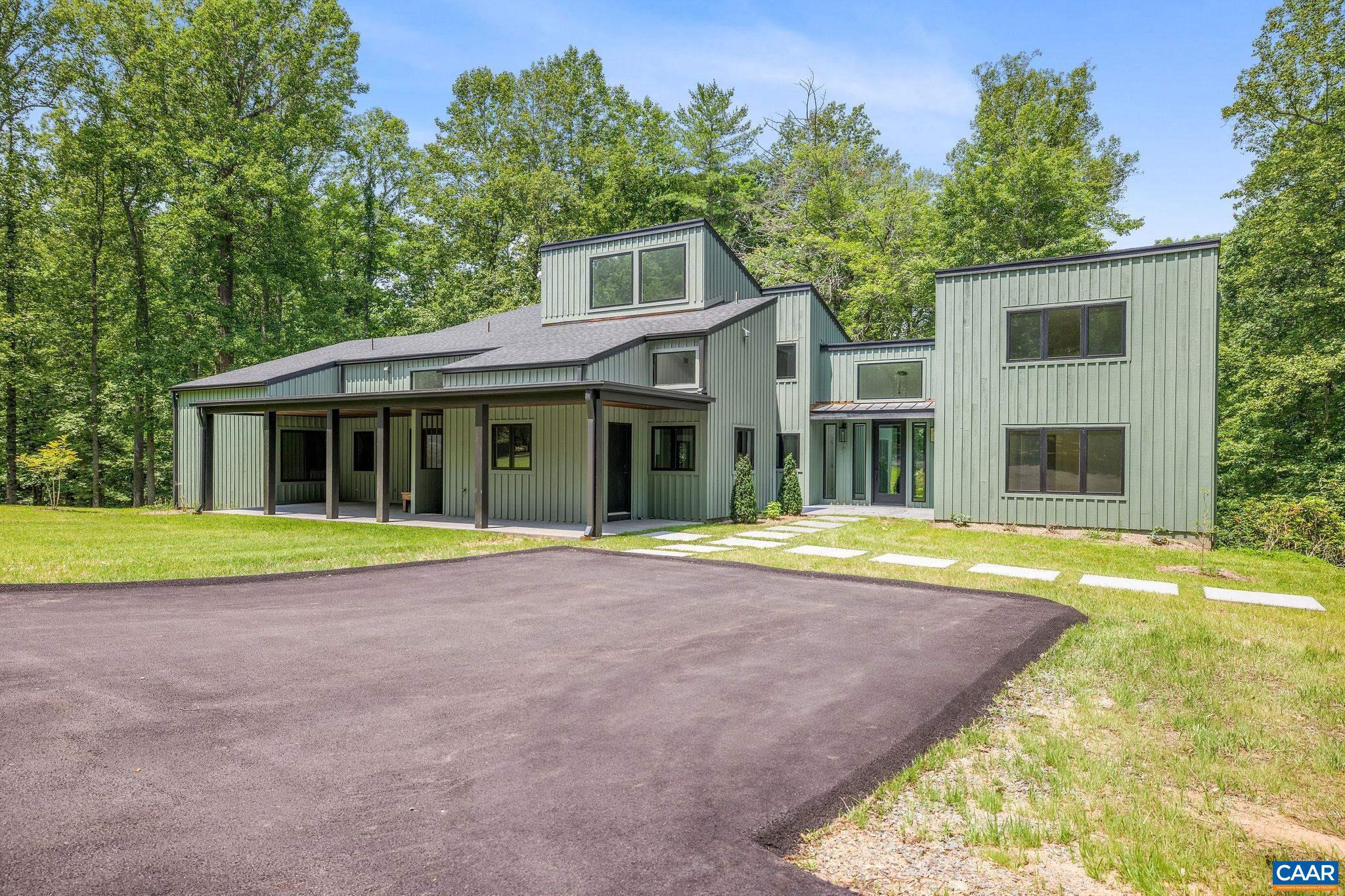This property has undergone flawless upgrades, elevating a well-built architectural gem to a supreme level of style, comfort, and quality. Offering 5 bedrooms and soaring interior spaces, the home features two first-level primary suites, including a private guest suite. The second level includes three additional bedrooms and two baths (one en-suite), along with multiple flexible spaces ideal for creative pursuits, offices, or studios. Designed for seamless indoor-outdoor living, enjoy coffee, cocktails, or dining on four porches, including a large covered wraparound porch. The stunning new kitchen showcases premium custom cabinetry and Viking appliances, flowing effortlessly into the open great room, cozy family room, wet bar, and outdoor entertaining areas. The great room?s striking fireplace anchors the space, complemented by a second fireplace in the inviting family room. The primary suite, great room, and family room all open directly to the covered porch. A separate yet connected guest primary suite linked via a glass walkway offers exceptional privacy and includes a second-floor office or workout space. Located on 11+ acres off Garth Road surrounded by conservation land, gives it rare privacy and blue ridge view opportunity.,Quartz Counter,Wood Cabinets,Fireplace in Great Room,Fireplace in Study/Library