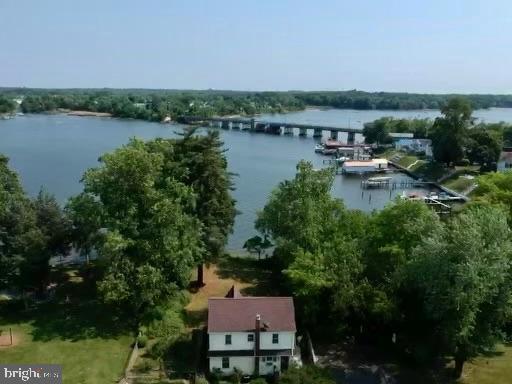 This Beautiful Waterfront Colonial Is Loaded with Character and Charm and underwent a major renovation in 2006-2007. The architectural roof, electrical upgrade, hardwood and laminate floors, gourmet kitchen, bath, fixtures and more are all from this era and look brand new. Kitchen features cinnamon maple cabinets, Corian counters, pantry with pull outs, tile backsplash, nickel fixtures and stainless steel appliances. Other features include high ceilings on main level, hardwood throughout, custom shades, ceiling fans, screened water view porch, Forced Air HVAC, partially finished basement with slate floors, mature landscaping, community beach, boat ramp, picnic area and playground access w/ optional $100/year fee. 
There is a waterfront lot in front of home owned by someone else with no access according to county. County calls this home waterfront but it is water view. Call for details. Hurry, this home will not last!