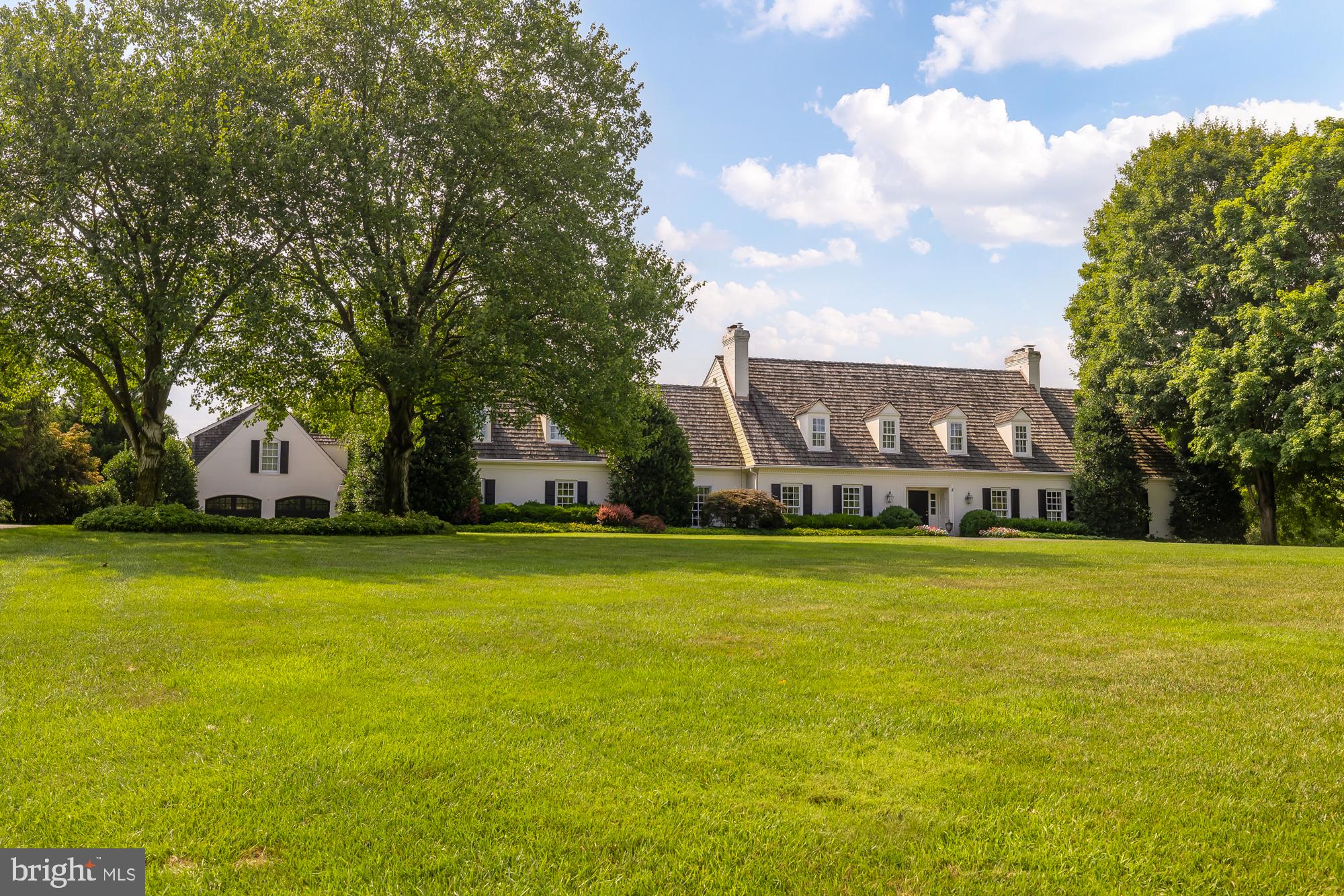 Welcome to 11101 Piney Meetinghouse Road, a remarkable estate offering the rare combination of privacy, convenience, and enduring craftsmanship. Situated on two picturesque acres backing to a 26-acre wooded preserve with a year-round stream, this Foulger Pratt-built residence provides a secluded retreat less than two miles from Potomac Village. Offered for the first time by its original owners, the property has been meticulously maintained and thoughtfully updated throughout.

Elegant yet inviting, the home features soaring ceilings, beautifully proportioned living spaces, and an effortless blend of formal and casual rooms designed for both everyday living and grand-scale entertaining. Highlights include a gracious living room, cherry-paneled library, sunlit music room, expansive family room, and a dramatic lofted dining space that opens seamlessly to the surrounding grounds.

The updated chef's kitchen, refreshed baths, whole-house generator, dual laundry areas, and extensive recent improvements provide modern comfort while preserving the home's timeless character. Public water, sewer, and natural gas—rare for a property of this size and setting—offer an added level of convenience and value.

The luxurious primary suite serves as a private retreat, featuring vaulted ceilings, a fireplace, dual dressing rooms, and a stunning wood-paneled study. The walkout lower level offers additional bedrooms, recreation space, and a light-filled fitness area, while the charming carriage house provides flexible accommodations with its own bedroom, living area, and kitchenette.

Outdoor living is equally exceptional. Stone terraces, a newer pool, gazebo, covered patio with fireplace, heaters, and integrated AV create a resort-like setting for entertaining and relaxation. Mature landscaping, an English garden, irrigation system, and deer fencing enhance the beauty and functionality of the grounds.

Recent updates include a new cedar shake roof (2024), refinished hardwood floors, fresh interior paint, new luxury carpeting, new hot water heaters, a replaced main water line, and a comprehensive fire and security system upgrade.

Properties offering two private acres, public utilities, natural gas, preserve views, and close proximity to Potomac Village are increasingly difficult to find. Combined with four garage spaces, abundant parking, and immediate occupancy, this is a truly rare offering in one of Potomac's most desirable locations.

The home is now vacant and move-in ready. Photography was completed while the home was furnished, allowing buyers to appreciate the scale, warmth, and character of the living spaces. Open Saturday 6/13 from 12-2 or reach out for a private showing.