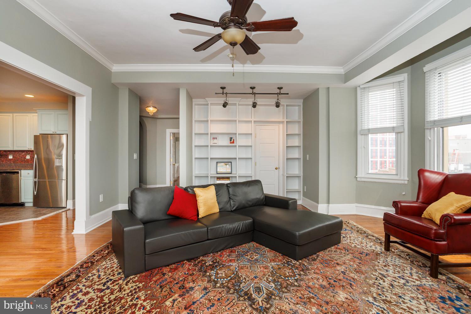 This is a beautifully renovated and maintained corner unit at the Lenox Condominiums. It is on the southeast corner of the building on a high floor with great light and views from three bay windows. It is the largest one-bedroom unit at the Lenox, as large as most two-bedroom units, and has one of the nicest layouts. It was originally designed for one of the developers to live in. The elegant entry vestibule has direct access via three archways to the living room, combined open dining room and kitchen, and the bedroom suite. The large living room has two bay windows with southern and eastern views, built-in custom bookcases, and a ceiling fan. The dining room has two south facing windows and two wall sconces. The kitchen has been completely renovated with custom cabinets, stainless steel appliances, and granite counter tops. At roughly 21’ x 25’ the bedroom suite is very large and includes a lounge area and a bed alcove. The lounge area has an original decorative fireplace mantel, custom shelving, bay window, and ceiling fan. The bedroom alcove fits a queen-sized bed with night stands, and the walk-in closet has a custom organizing system. The lounge and bedroom areas can easily be reversed with the smaller area being used as a den and the larger space used as a more formal bedroom. The bathroom has entrances from both the living room and bedroom lounge. The home has central air conditioning via ductless mini-split systems. The Lenox was designed by famed New York architects Clinton and Russell. It was built in 1920 as an apartment building and renovated into condominiums in 2004-5. The units have large scale rooms, high ceilings, lots of windows and most units have many of their original architectural elements. It is a doorman building and is centrally located at the southern end of Mid-town Village in Washington Square West neighborhood. It is two blocks from the great shops, restaurants, theatres, Kimmel Center and night life of Midtown Village, Walnut Street, and the Avenue of the Arts. It is also just a few blocks from Thomas Jefferson and Pennsylvania Hospitals. There are many gym, parking, and public transportation options nearby. The Lenox has a large central laundry room, but the association allows owners to install individual units within their condos, with some restrictions and installation requirements. Condominium fees include a 24/7 door staff, heat, hot water, and high-speed internet. The owners pay their own electric and Cable TV. The association offers additional storage for a small fee. It is a pet friendly building. The association plans to replace the three elevators in the next 18 months and the seller plans to pay the assessment in full prior to settlement provided they receive an acceptable offer. There is a gated parking space behind the building that is for sale for $70,000.