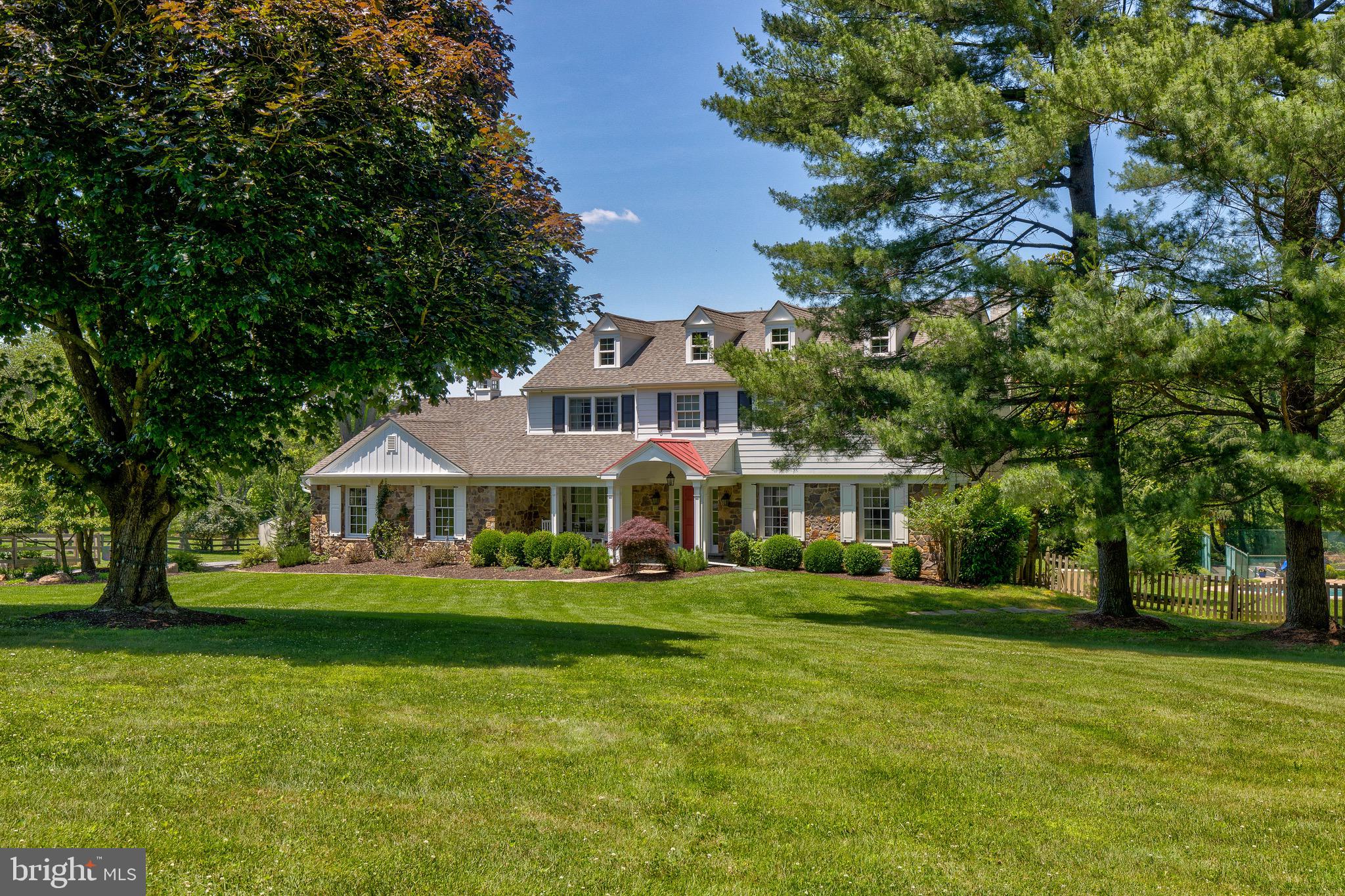 Welcome to Sagecroft Farm, a country estate nestled in the heart of prestigious Willistown
Township and Radnor Hunt countryside. Set on four beautifully fenced and pastured acres, this
remarkable property offers the rare opportunity to enjoy the tranquility of rural living without sacrificing
modern conveniences. Complete with a three-stall barn, wash bay, and ample space for horses and backyard friends, Sagecroft Farm embodies the very best of the Chester County lifestyle.
Your journey begins along a gently winding, picturesque country road before arriving at 12 Chowning Drive,
Thoughtfully renovated and meticulously maintained, the home showcases expansive vistas and the surrounding natural beauty from nearly every room.  The home features a traditional center hall entry foyer with adjacent formal dining and living areas. The expansive open-concept kitchen and breakfast area  overlook the spectacular grounds and newly renovated pool and patio (2026). The sun-filled kitchen serves as the heart of the home, featuring an oversized center island with farmhouse sink, JennAir cooktop, Bosch dishwasher, abundant seating, a 42-inch built-in side-by-side refrigerator, double wall ovens, microwave, and warming drawer— perfect for everyday living and entertaining. Conveniently located off the garage, the mudroom and laundry area provide practical functionality, while a
dedicated exercise room and sunroom complete the first floor. The upper level offers 4 bedrooms, a master suite with walk-in closet and additional built-ins for storage, and recently renovated hall bathroom with dual sink vanity. The finished lower level offers exceptional versatility, featuring a spacious recreation and entertainment area, a custom-designed bar with beverage center and live-edge countertop, and a full bath with direct outdoor access—ideal for poolside guests. Additional highlights include a utility sink, dedicated workspace, and two storage areas. Outdoor amenities include a full-size tennis court, raised-bed vegetable garden, mature peach tree, predator-proof chicken coop, fire pit, Trex deck, and a charming three-stall barn complete with tack room, wash bay, and additional garage space. Whether enjoying fresh produce from your garden, caring for horses, gathering around the fire pit, or relaxing poolside, every day feels like a retreat. As evening falls, experience unquestionably spectacular sunsets, celestial panoramas, and the peaceful stillness that only country living can provide. Yet despite its idyllic setting, Sagecroft Farm is ideally located within the highly acclaimed Great Valley School District and just minutes from Episcopal Academy, Malvern Prep, the vibrant boroughs of Malvern and West Chester, King of Prussia, the Main Line and Philadelphia International Airport. Sagecroft Farm is more than a home—it is a lifestyle, offering privacy, beauty, and timeless Chester County charm in one extraordinary setting.