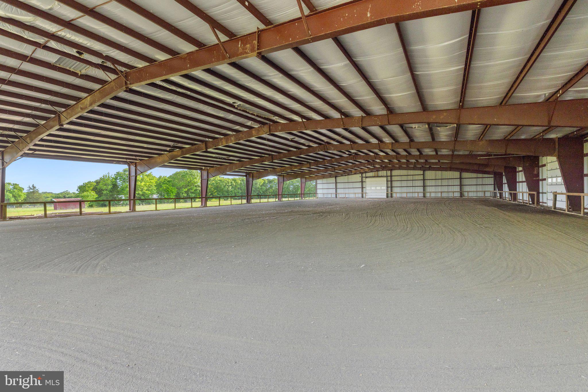 Welcome to your dream equestrian property nestled on 24 acres of picturesque land, offering unparalleled amenities for both horse enthusiasts and those seeking a tranquil countryside retreat. Zoned A-1 in the heart of Prince William County.

As you enter the property, you'll be greeted by a quality crafted 15-stall barn, featuring an asphalt floor and custom-designed dirt stone stalls  with removal partitions to expand stall size, if desired. Each stall boasts 36" x 36" Anderson glass windows that open, providing ample natural light and ventilation for your beloved equine companions. A dedicated 12' x 24' foaling stall equipped with heat lamps ensures the safety and comfort of newborns.

The barn, with a new roof installed in 2018 and updated gutters in 2019, also includes essential facilities such as a washing area with hot/cold water available, dedicated office space, and a tack room for all your equestrian gear storage needs.

In addition to the barn, discover the impressive 115' x 200' covered riding arena, constructed in 2017 and never used, offering endless possibilities for riding, instruction, competitions, and more. Featuring 14' x 14' commercial doors, buried downspouts, and commercial-grade insulation, this arena is designed to accommodate various riding disciplines and can also cater to other types of livestock activities.

Additional amenities include a 20' x 30' storage barn with a concrete floor, metal roof, and electricity, perfect for equipment storage or potential expansion. The property also boasts several outbuildings, providing ample space for various uses.

Nature lovers will appreciate the serene beauty of Slate Run, which meanders through the rear of the property, with the boundary extending to the other side of the creek, offering a peaceful backdrop for outdoor activities and relaxation.

The main residence epitomizes comfort and convenience with main-level living featuring three bedrooms and two bathrooms. Enjoy breathtaking pasture views from every room, including the four-season enclosed porch, ideal for unwinding and soaking in the surroundings. A cozy family room with a wood-burning stove and stainless flute sets the ambiance for cozy evenings, while an expansive converted space offers versatile options for entertainment or an additional bedroom, complete with a tile floor and mini-split system.

Step outside onto the large patio and embrace outdoor living at its finest, surrounded by lush greenery and tranquility. All sliding doors are 8' with the exception of the front entrance, seamlessly blending indoor and outdoor spaces. The home is adorned with Pella Doors &  Windows throughout, ensuring energy efficiency and natural light flow.

Recent updates include new kitchen appliances in 2024, along with new gutters and vinyl siding. A new roof was installed in 2018, and all kitchen and bath fixtures are by Moen. Other notable features include attic fans installed in 2018, a primary bath update in 2023, a water softener system, a new hot water heater in 2020, and a new HVAC unit (interior/exterior) in 2011, ensuring comfort and convenience year-round. Home is wired for a whole house generator.

Don't miss this rare opportunity to own a truly exceptional equestrian property that combines luxury living with unparalleled amenities in a breathtaking natural setting. Schedule your private tour today and experience the epitome of country living at its finest!