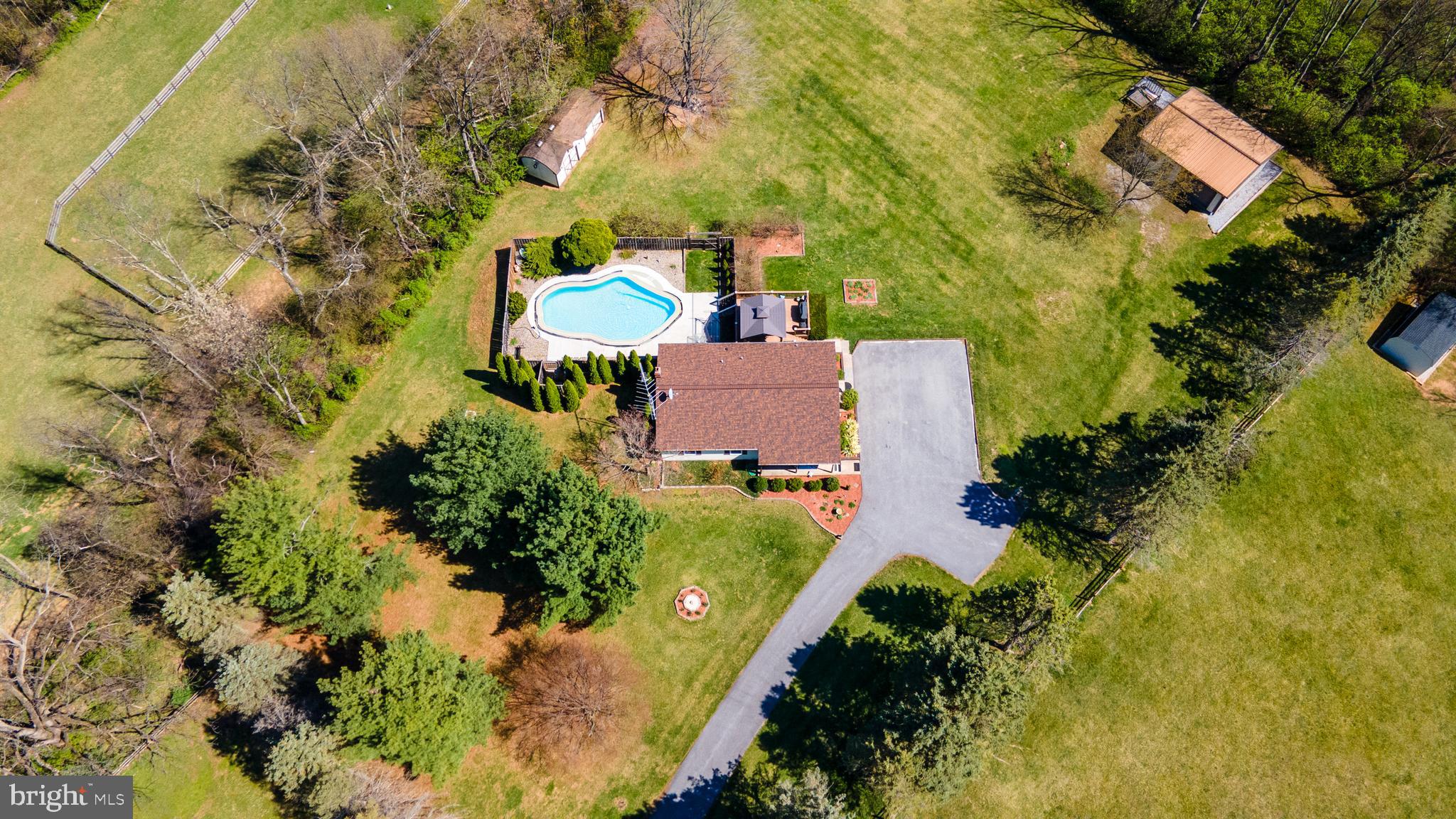 Do you have peace and tranquility on your mind? Then look no further, this stunning Ranch Home sitting on just about 2 Acres in Westminster MD close to the MD/PA line is now available! Offering 3 bedrooms, 2 full bathrooms, & a fully finished basement to host your family gatherings or cozy up by the soap stone wood burning stove! The kitchen has marbled black granite counter tops, tile backsplash, double oven, breakfast bar, & double door leading out to the maintenance free deck overlooking the pool and yard!  With summer right around the corner you're going to LOVE dipping into your own private In ground swimming pool and barbequing on the deck or patio! The oversized heated garage has plenty of room for any handyman or car enthusiast with a ramp/ lift, workbench, & air compressor! This home has been VERY well maintained. The pool has been redone in 2023, Newer Roof in 2022, replacement windows within the last 10 years, paved driveway & fresh carpet throughout the finished lower level! This home is a one stop shop! You must check it out!