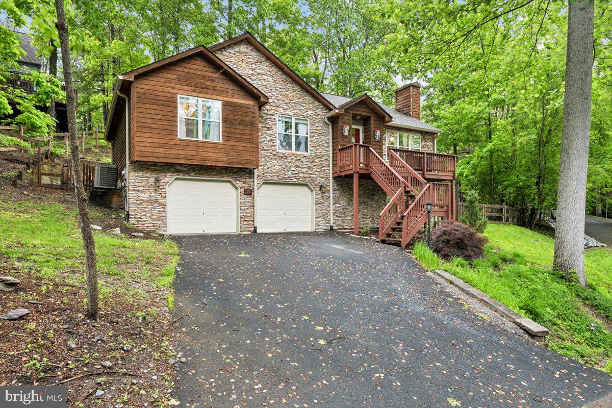 Welcome to this Beautiful Oasis in Balmoral Overlook with Lake Views. Walk inside the home to be greeted with vaulted ceilings, stone fireplace, open concept family and dining room. The kitchen is the star of this level, featuring Gorgeous Granite, 42 inch Cabinets, Island with Newer GE Cafe Series appliances.  French doors off the kitchen lead to a rear deck, and a fully fenced in yard. An Irrigation system runs from the back deck through the gardens and down around to the  front flower beds. 

Be sure and admire the updated lighting/ceiling fans!  Don't let their size fool you, turn them on and feel the power (dining and primary bedroom).  In 2020 a new 30 year architectural  roof was installed in addition to a gutter system , of which the current owner has had cleaned out professionally, every quarter.  The HVAC is only 7 years young, and Hot Water Heater 9 years young.

Walk back the hall to 3 generous sized bedrooms, hall bath. As well as a  large tub and shower Primary Room En-Suite!!  Laundry is also on the upper bedroom level!  From this hall,  a connecting stairway takes you to the Fully Finished basement.  Basement features large rec room with Custom Built Ins. Rec room has been previously wired for surround sound, and has a rough in for water source.  An additional bedroom and full bath are also on this level as well as a Mechanical room and access to and from the Oversized 2 Car Garage.