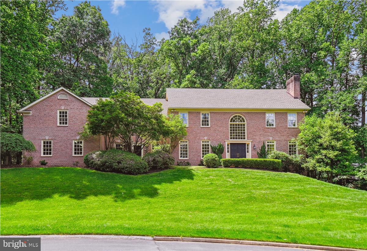 Circular Drive leads to this impressive, over 7,000 sq. ft., all-brick Georgian-style home on 1.82 acres, situated in quiet Cul-de-Sac.  Front double doors lead to a two-story foyer with an elegant curved staircase and Palladian window.  This home features five bedrooms, five full and one-half baths, and 10’ ceilings on all three levels.  Wide cherry hardwood flooring on the main level. Large Living Room with multiple windows with transoms and a fireplace.  Pocket doors to Library/Office with Custom Built-ins and Window Seat.  This room could be used as a bedroom if needed.  It is right next to the full bath.  The formal dining room has transom windows, intricate detail moldings, and a built-in cabinet.  The kitchen features glass front cabinets,l plant shelf, a large Island seating five or more, a prep sink, a desk for recipe reading, or a bar. The kitchen table area is conveniently located next to the second staircase to the upper level.  Hardwoods are under carpet on both staircases and in the upper hallway. The Family Room is off the Kitchen with Custom Built-ins, including a wet bar and Fireplace.    Bright Light-filled sunroom with Palladian windows, Skylights, Ceramic Floor, Atrium Door to Trex Deck overlooking landscaped yard.  The upper level features a large Primary Bedroom with a Fireplace, walk-in closets, a Luxurious Bath, expansive counter space, a makeup area, a Whirlpool Tub, and a separate shower.  Three additional Bedrooms, One with a private Bath and the other two bedrooms with a Jack and Jill bath.  The huge Bonus Room currently used as recreation/office has a private bath and balcony.  This room could be used as an in-law suite.  Outside this room is an Elevator Channel for possible future needs.  This continues from the second floor to the first and also to the lower level.  Expansive lower level with Walk Out to ground level has a raised hearth, brick fireplace and rough-in for bath.  Four-car side entry Garage.  The second Entrance Door from the front of the house leads into the Mud Room Area.  Four Zone Heat.  There is so much storage! Central Vac.
