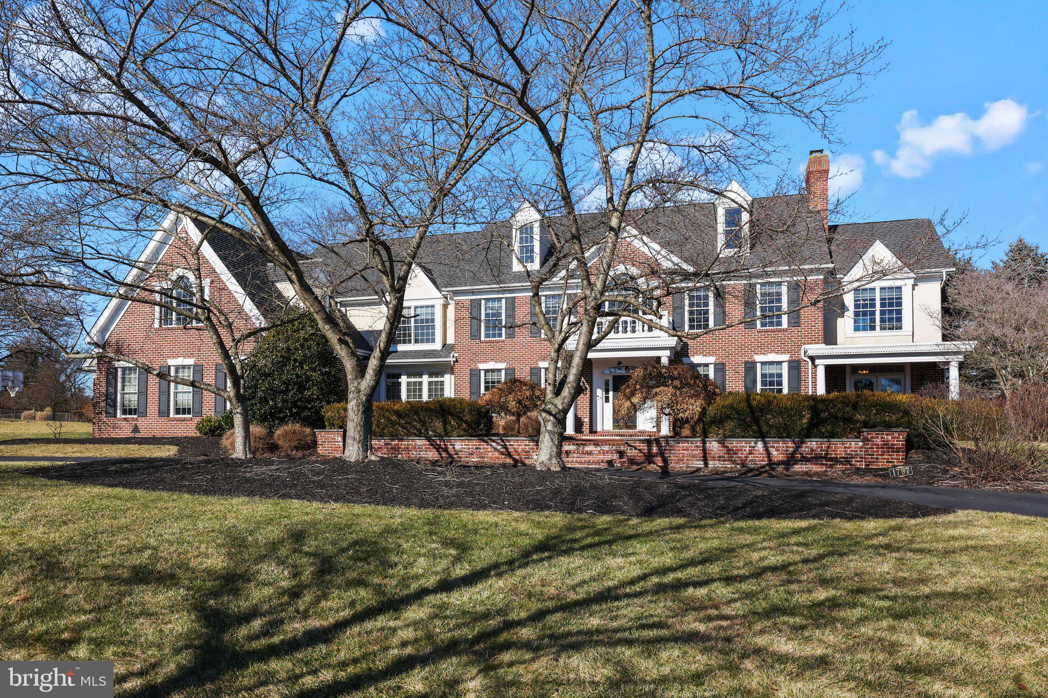 Discover the epitome of luxury living in Worcester, Pennsylvania, at 1797 Hawks Nest Lane in the prestigious Fawn Creek neighborhood. This Georgian Brick Colonial masterpiece stands as a testament to grandeur and elegance, nestled on 1.5 lush acres. Offering nearly 6,000 Sq/Ft of exquisite living space, this residence features four bedrooms, five baths, a three-car attached garage, a game room on the 2nd floor, an expansive full unfinished basement, and a breathtaking custom Anthony & Sylvan pool, complete with a cascading waterfall.

Upon entering the grand foyer, the allure of classic hardwood floors, arched ceilings adorned with dentil crown molding, wainscoting, and a majestic solid oak staircase greet you. The home’s sophisticated design is further accentuated by enlarged windows, custom crown woodwork, and a striking chandelier. The inviting layout includes a home office space with elegant French doors in a sun filled room, leading to an intimate Pennsylvania Blue Stone patio with a firepit. A sun-drenched, tile-floored sunroom and a convenient half bath near the office entrance provide serene retreats.

The formal living room welcomes you with a gas fireplace, adorned with a gorgeous marble-surround, intricate mantle, and high ceilings. The large dining room has enough room to fit 12+ people.

The brand new chef’s kitchen boasts a sprawling center island, top-tier Thermador and Bosch appliances, a walk-in pantry, brand new Raised Panel cabinets, and gleaming quartz countertops. This culinary haven opens to a cozy breakfast area and a great room anchored by a brick front gas fireplace for ease of entertaining.

The luxurious main bedroom on the second floor features a private sitting area, dual walk-in closets, and a spa-like bath with a jetted tub and dual vanities. The three large additional bedrooms offer ample storage and walk-in closets, alongside a charming library/den with panoramic views. An expansive bonus room above the garage offers versatile space, possible two additional bedrooms.

The elegant patio, leading to the 30,500-gallon gated Anthony & Sylvan pool, serves as a private oasis for relaxation or entertaining. This property also comes equipped with a robust 27 kW Generac generator that turns on automatically if the power goes out. It is strong enough to power the whole house.

Recent updates include new bedroom carpeting, a new kitchen and updated breakfast area flooring, and a freshly replastered pool. Don’t miss the opportunity to own this unparalleled property, where luxury meets comfort. Schedule your visit to 1797 Hawks Nest Lane and embrace the lifestyle you deserve.