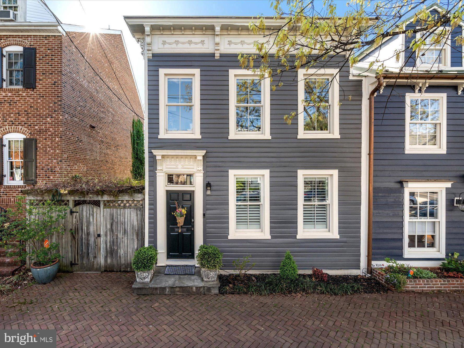 Step into timeless sophistication with this exquisitely restored Victorian home, ideally situated in the heart of historic Old Town Alexandria. Meticulously reimagined by esteemed local developer William Cromley, this end-unit residence seamlessly blends the charm of the past with the luxury of modern living.

Offering 3 spacious bedrooms and 3.5 impeccably designed bathrooms, this light-filled home showcases architectural craftsmanship at its finest - featuring soaring ceilings, premium finishes, and refined details throughout. From the moment you enter, the open-concept layout invites effortless entertaining, with elegant flow from room to room.

The gourmet kitchen is a culinary dream, appointed with striking marble countertops, a bespoke backsplash, rich custom cabinetry, and a full suite of top-tier appliances. Premium dual-pane Jeld-Wen wood windows bathe the home in natural light, while automated Hunter Douglas shades provide both ease and elegance. 

Just off the kitchen, the rear glass conservatory is an architectural jewel - featuring 10-foot ceilings, elegant slate flooring, and a cozy fireplace. Whether you're enjoying a quiet morning coffee or hosting an intimate evening gathering, this luminous space offers a truly special place to relax and unwind.

Outside, enjoy a private backyard oasis with manicured landscaping, maintenance-free turf, and ample space for al fresco gatherings. In spring, the redbud tree out front and cherry trees in the rear burst into bloom, adding natural beauty to this exquisite home.

Upstairs, a serene primary suite awaits, complete with tranquil views and a spa-inspired en suite bath boasting dual vanities, marble surfaces, a freestanding soaking tub, and a separate glass-enclosed shower. Each additional bedroom offers its own sense of style, comfort, and custom storage. 

The lower level offers versatile bonus space ideal for a guest retreat, home office, gym, or den and a workshop.

Additional features include:
- Dual-zone Trane HVAC system  
- Solid hardwood and slate flooring  
- Custom glass stair railings and skylight  
- Designer marble bathrooms and custom closets throughout  
- Two fireplaces  
- Plantation shutters  
- Convenient upstairs laundry  
- Easy street parking  

Perfectly positioned just steps from King Street’s vibrant dining and shopping, as well as North Old Town, Trader Joe’s, and Harris Teeter. Morning coffee at The Chewish Deli? Just around the corner. Metro access and major commuter routes are also just moments away.

Better than new construction in every way, this one-of-a-kind residence delivers unmatched quality, location, and timeless allure. Come experience the pinnacle of Old Town living.