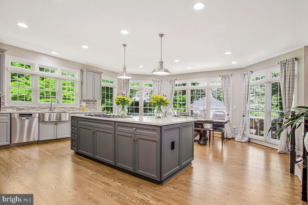 Fully renovated luxury estate on nearly one acre in the sought-after Ashley community of Davidsonville, offering over 7,300 sq ft of finished living space, including 5,572 sq ft above grade. This move-in-ready home blends scale, privacy, and high-end upgrades rarely found in a single offering.

A dramatic two-story foyer and family room with soaring ceilings and gas fireplace anchor the main level. The fully renovated gourmet kitchen features custom cabinetry, oversized quartz island, Bertazzoni gas cooktop, Bosch double wall ovens, and a brand new Sub-Zero 36” built-in refrigerator. Butler’s pantry includes wine storage, wine refrigerator, ice machine, and additional beverage storage. Sunroom/observatory with double-sided fireplace provides abundant natural light and year-round enjoyment.

Hardwood flooring extends throughout the main and upper levels, creating a seamless, elevated look, and has been professionally refinished to enhance both beauty and durability.

Main level includes a dedicated executive office with wall-to-wall custom built-ins, along with formal and open living spaces ideal for entertaining.

The upper level features a spacious primary suite with tray ceiling, sitting area, and fully renovated spa-style bath with heated floors, oversized multi-head shower, and dual vanities. All bathrooms throughout the home have been fully renovated with modern finishes.

The finished lower level offers exceptional flexibility with a private guest bedroom hidden behind a custom feature wall with concealed double-door entry, full bath, dedicated fitness area, and expansive entertainment lounge with custom cherrywood wall unit, integrated television, Bose surround sound, and theater-style reclining seating. Bar area includes built-in cabinetry, full-size refrigerator, and additional cold storage, along with a separate office workspace with dual built-in desks.

Outdoor living is designed for both relaxation and entertaining with a multi-level deck, gazebo, outdoor kitchen, professional landscaping, irrigation system, landscape lighting, and fenced backyard backing to wooded privacy.

Additional features include natural gas heating and cooking, Generac home backup generator, new water heater (2024), roof replaced (2021), dual-zone HVAC, ADT security system with CCTV, and a three-car side-entry garage with epoxy-coated flooring, equipped with an EV charging port and pre-wired for a second charging station.

Select premium features convey, including Samsung Frame TVs, custom media console, theater seating, built-in office workstations, dining table with bench and chairs, outdoor furniture, mini freezer for additional storage, and fitness equipment including Tonal system, Smith machine, and dumbbell tower set.

Conveniently located with access to major commuter routes and zoned for top-rated Davidsonville schools.