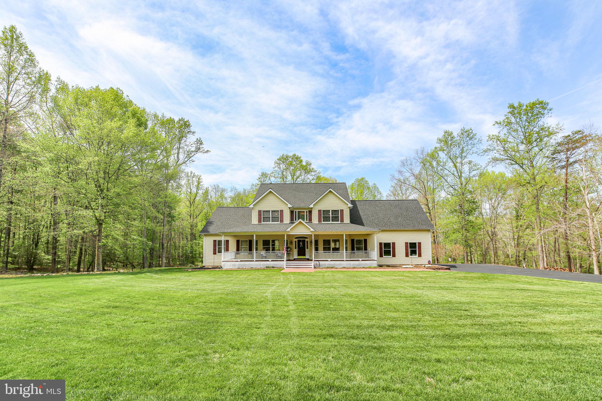 Nestled in a private equestrian community with property acreage of 10+ acres, this rare offering delivers the perfect blend of nature, privacy, and refined living. King’s Grant features miles of maintained riding trails, a community barn for private events, and a volunteer-run HOA that maintains roads, snow removal, and common areas; all while only a short 1.5 hrs from Washington, DC.  
Situated on 19.69± acres, this property offers beautifully manicured grounds, extensive, usable flat land, and a picturesque setting complete with a "year-round" creek (Alcotti Run Creek) and private trails. Springtime brings stunning bluebells, creating a truly storybook landscape.  This immaculate, ESTATE-sized home offers 5-6 bedrooms (LL bedroom NTC), 4.5 bathrooms, Fresh paint (interior & exterior), New carpet (April 2026), Roof (Nov 2025), Dual-zone HVAC, Water heater (3 years), Garbage disposal (1 year), Upgraded septic system (4 years old), & 165-ft deep well offering what the seller reports is "the best water in Stafford County!"  The main level features impressive hardwood floors carrying through to the expansive family room where it meets the brand new upgraded carpet, abundant natural light, and stone gas fireplace for those cozy winter nights.  The kitchen is designed for functionality with abundant cabinetry, large workspace, pantry, table space, breakfast bar, island, and newer stainless steel appliances (refrigerator & microwave). Large Main-level primary suite includes an ensuite bath with soaking tub, separate shower, & dual vanity, as well as a private access door to your beautiful rear deck.    Upper level offers 3 spacious bedrooms, including one bedroom with designated bath and another featuring a  Jack-and-Jill bath for the other two bedrooms. Lower level features a large recreation room with wood stove, 2 additional flexible rooms, and walkout access.  Storage room in the lower level is grand and also offers a "safe room" area, to be completed, if desired.  Outdoor living is exceptional with a full-length Trex deck, stamped concrete patio that meanders around to the 2-car garage and pedestrian door, and thoughtfully designed walking and riding trails throughout the property.  Exterior has recently been refreshed with new paint and power washing. High-speed Xfinity internet is available and currently utilized, or satellite.  There are (2) 200amp breaker panels- allowing for future expansion & the Generator also conveys (with a dedicated switch for simplicity of operating your essentials, when needed).  
This METICULOUSLY maintained ESTATE-STYLE property is an equestrian lovers opportunity  & offers a peaceful retreat & perfect place to call "HOME!"   With the sheer size of this home, year round creek, & the large acreage, you have so many options- increase the size of the home, add finished space above the garage, build a beautiful barn, cultivate a garden oasis, or even design your own private pool....  all while only a little over an hour (55 miles)  from Washington, DC!  Come see!  (Some photos have been virtually staged)