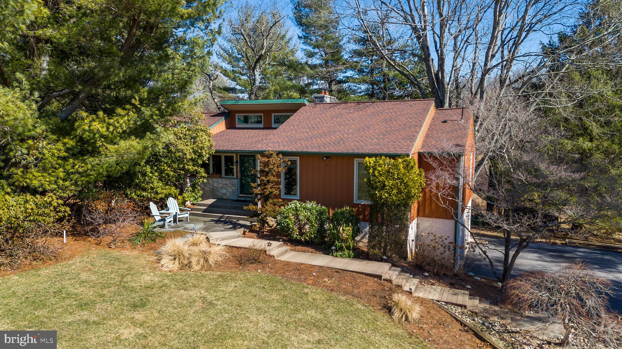 Welcome to 903 Briar Wood Ct, a beautifully maintained 1-acre retreat nestled in the peaceful Harmony Hills neighborhood within the highly sought-after West Chester Area School District. This charming raised ranch offers 3 bedrooms, 2 full bathrooms, and an oversized 2-car garage with a dedicated workshop. From the moment you arrive, you'll be welcomed by a Trex walkway leading to a bluestone front patio—the perfect spot to enjoy your morning coffee. Step inside to a bright and inviting foyer featuring a tile floor, coat closet, and stunning views through the rear slider to the picturesque wooded lot. To the left, the well-appointed kitchen boasts propane cooking, quartzite countertops, a tile backsplash, and a central island with a breakfast bar. Adjacent to the kitchen, the dining room showcases gleaming hardwood floors and sliding glass doors leading to a tiered rear deck with a pergola—ideal for entertaining or unwinding with a drink as you take in the tranquil surroundings. From the dining room, step down into the sunlit family room, where a vaulted ceiling and a stone-hearth propane fireplace create a cozy ambiance. The current owners have cherished many winter mornings here, sipping coffee by the fire as the snow falls outside. On the opposite side of the foyer, you'll find the private bedroom wing. The spacious primary suite features vaulted ceilings, abundant natural light, a walk-in closet, and an updated en suite bath with a tile step-in shower and modern vanity. Two additional bedrooms are served by a well-appointed full hall bath. The main level is completed by a convenient laundry room equipped with built-in cabinetry and a utility sink. Downstairs, the partially finished lower level provides additional flexible living space—ideal for a home office, rec room, or fitness area—with sliding glass doors leading to the walkout-level backyard. There's also a large unfinished storage area with easy access to mechanicals, as well as a direct entrance to the oversized 2-car garage. Don't miss the garage workshop, a dream space for any at-home tinkerer or hobbyist. The driveway has an RV parking pad for the road travel enthusiast. The sellers' favorite features of this home include its peaceful, scenic location, proximity to nearby open spaces and trails, including a neighborhood trailhead to Paradise Valley Nature Preserve, and the convenience of major travel routes and West Chester Borough’s vibrant dining, shopping, and community events. Don't miss this rare opportunity to make 903 Briar Wood Ct your own!