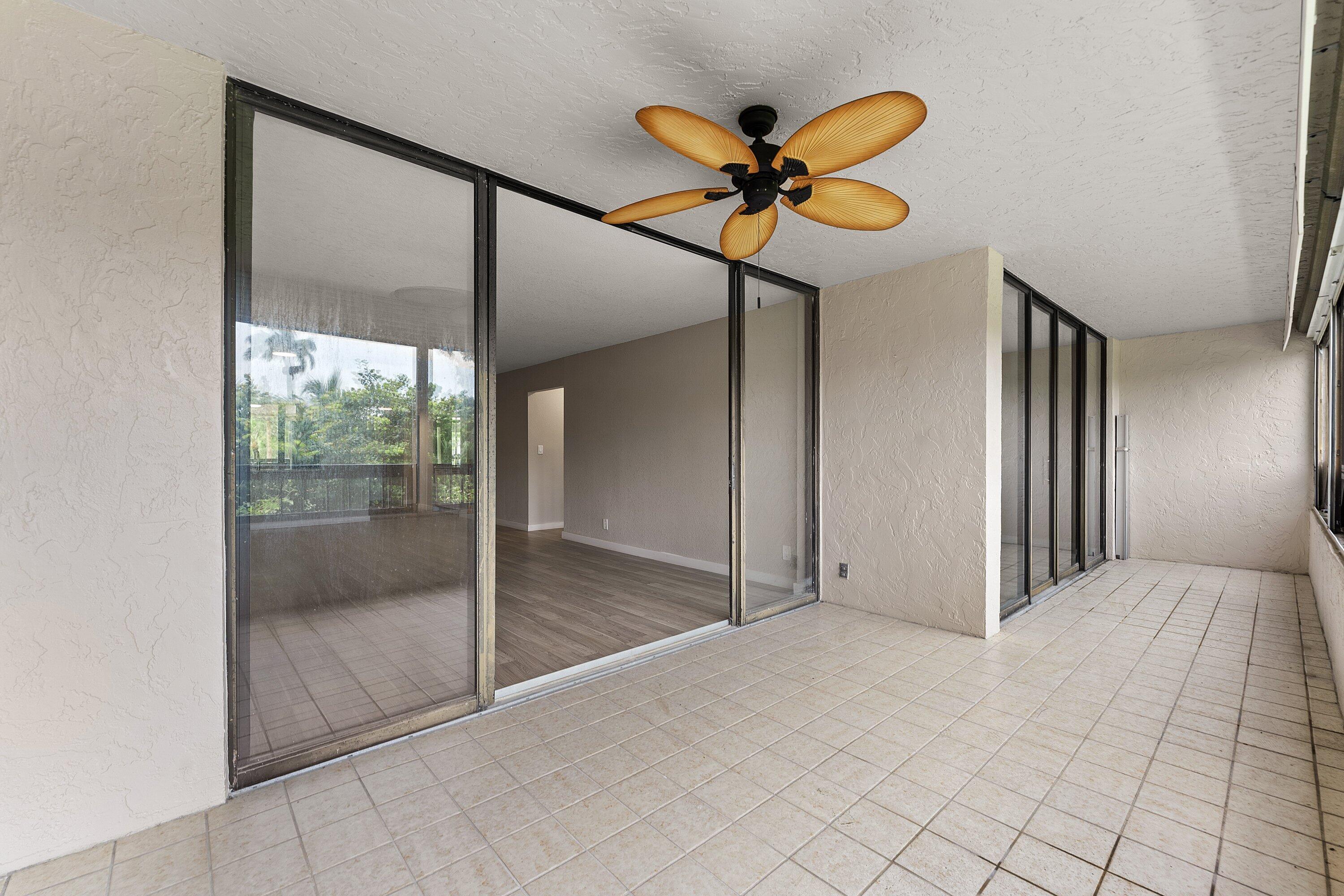 Welcome to this spacious beautifully updated two-bedroom, two-bath residence in The Glens of Boca Del Mar with serene views of Mizner Grand's golf course from the screened balcony. Set on the second floor, this 1,207-square-foot condo features a stacked-bedroom floor plan, wide-plank wood-look flooring, neutral finishes, generous living and dining areas, and large sliders that open to an expansive outdoor living space. The renovated kitchen is finished with white shaker-style cabinetry, stainless steel appliances, a subway-tile backsplash, updated countertops, an under moun sink, and a pass-through to the main living area. Both bathrooms have been refreshed with updated vanities and modern fixtures, including a dual-sink vanity and walk-in shower. The Glens offers a quiet, established  setting in the heart of Boca Del Mar, surrounded by beautiful landscaping and everyday convenience. Enjoy central Boca Raton living close to Town Center, Mizner Park, restaurants, parks, golf, beaches, Sugar Sand Park, Gumbo Limbo Nature Center, and major roadways. With updated interiors, golf course views, and access to the best of Boca living, this residence delivers the relaxed South Florida lifestyle buyers are looking for.