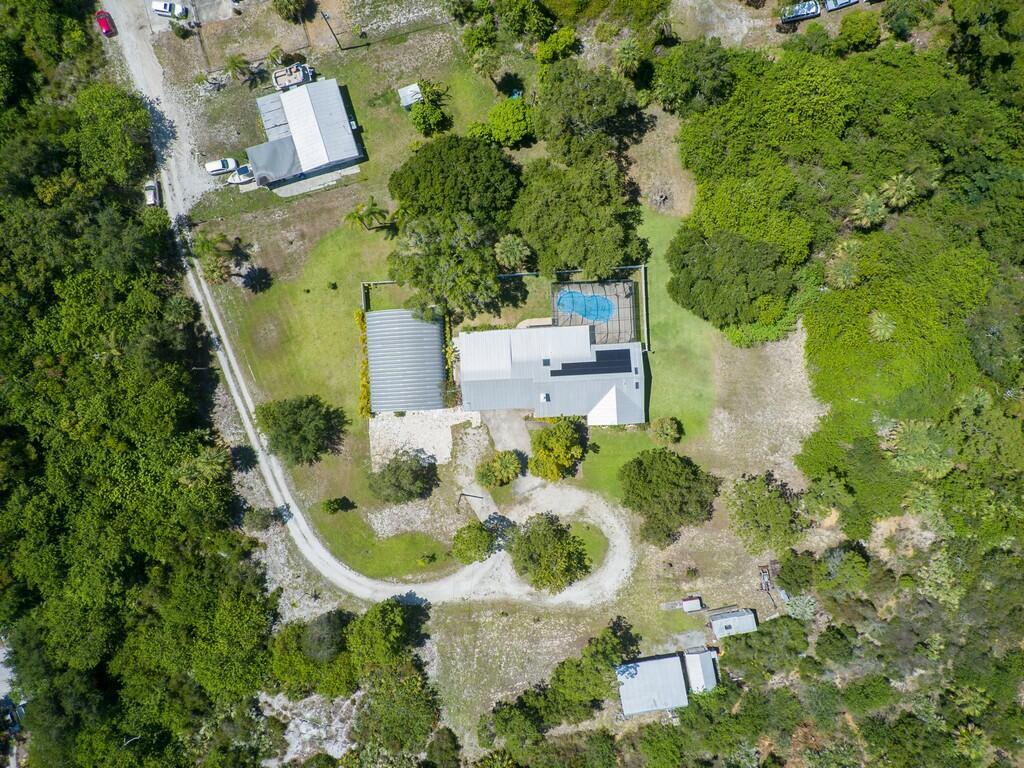 Unique rental opportunity in Vero Beach offering the perfect combination of comfortable living and exceptional workspace. This well-appointed single-story home features 2,374 square feet of living space with 4 bedrooms and 3 bathrooms, plus a two-car garage.  Situated on a spacious private lot, the property includes a large, detached shop/building ideal for contractors, business owners, hobbyists, boat or RV storage, and anyone needing extra workspace. Enjoy the screened pool, circular driveway, abundant parking, and room to spread out in a peaceful country setting.  A rare find for tenants seeking both a quality residence and substantial shop space in one property. Tenant use of the shop is subject to owner approval.