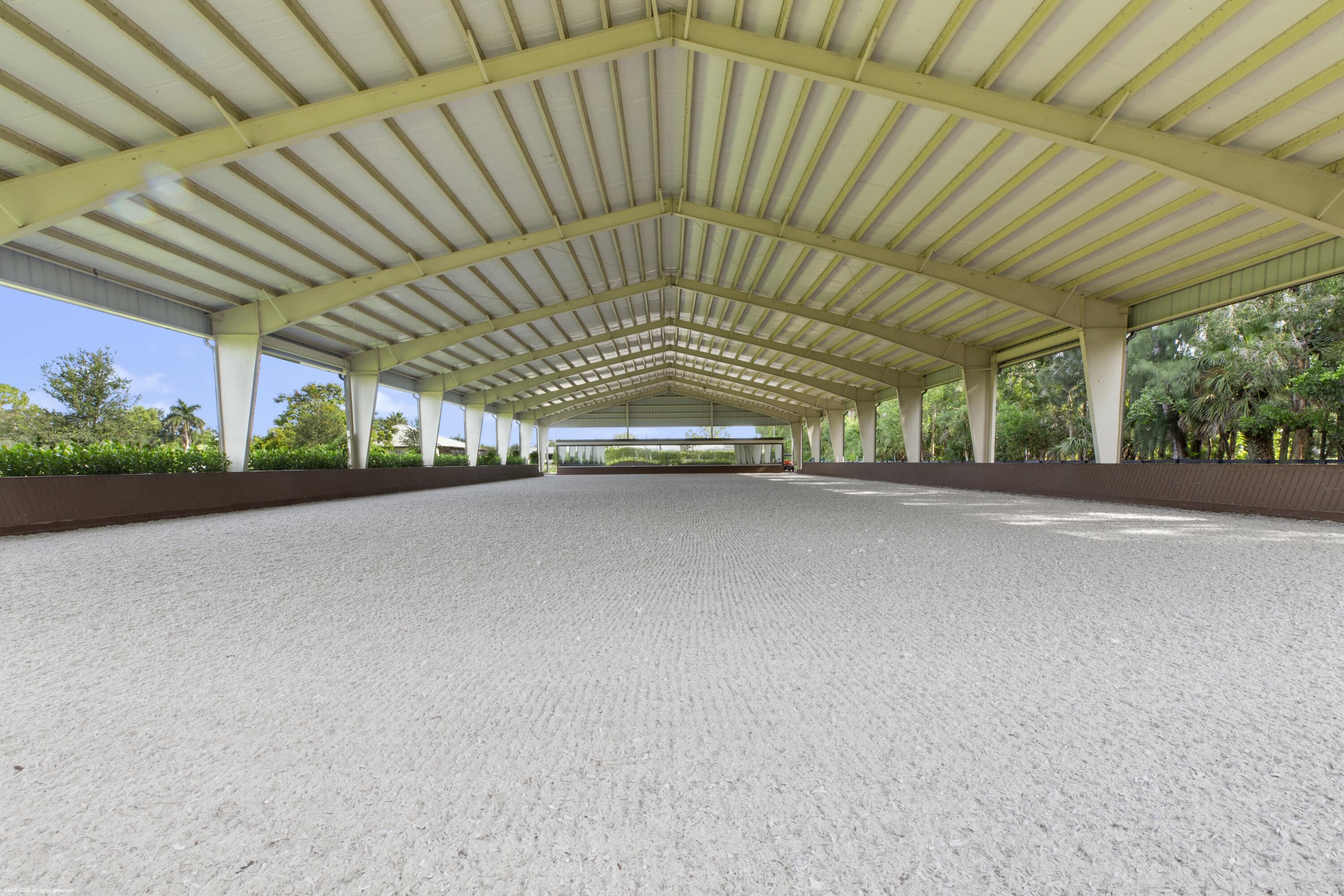 Get Covered! You can get of the sun when you buy this 5-acre farm which boasts an updated 3Br/3Bth home, 20 stalls, covered riding arena, outdoor arena & grass field! The main center-aisle barn has 16 stalls with feed, tack & laundry rooms, plus a studio apartment. The new covered arena with mirrored wall has an additional 4 stalls, grooming area, feed & tack rooms, Both arenas have ebb & flow watering systems. There are 7 grass paddocks, round pen, and a 4-horse walker. The house has been freshly updated with new floors, all new bathrooms & updated  kitchen. There is plenty of room on the property to build a larger main residence and then current home could then become staff housing. This property has unlimited options and is in a prime location just minutes from all competition venues. 150 x 110 outdoor arena
The covered arena is a full size dressage arena with no maintenance kick-walls by ChoiceDek.
The covered arena is 172 miles/hour wind rated
RV hookup at stable.
Separate gated barn entrance
The barn is on a separate electric meter.
Pond irrigates the arena. 10 horse power pump to fill the pond.
3-peak exhaust fans in barn aisle
Air-conditioned storage shed for hay.
2 Wells on the property - one for house & barn, and one for irrigation.
Rubber matted aisleway. 
Fly-spray system in stable.

1 AC zone - approx. 3 years new.