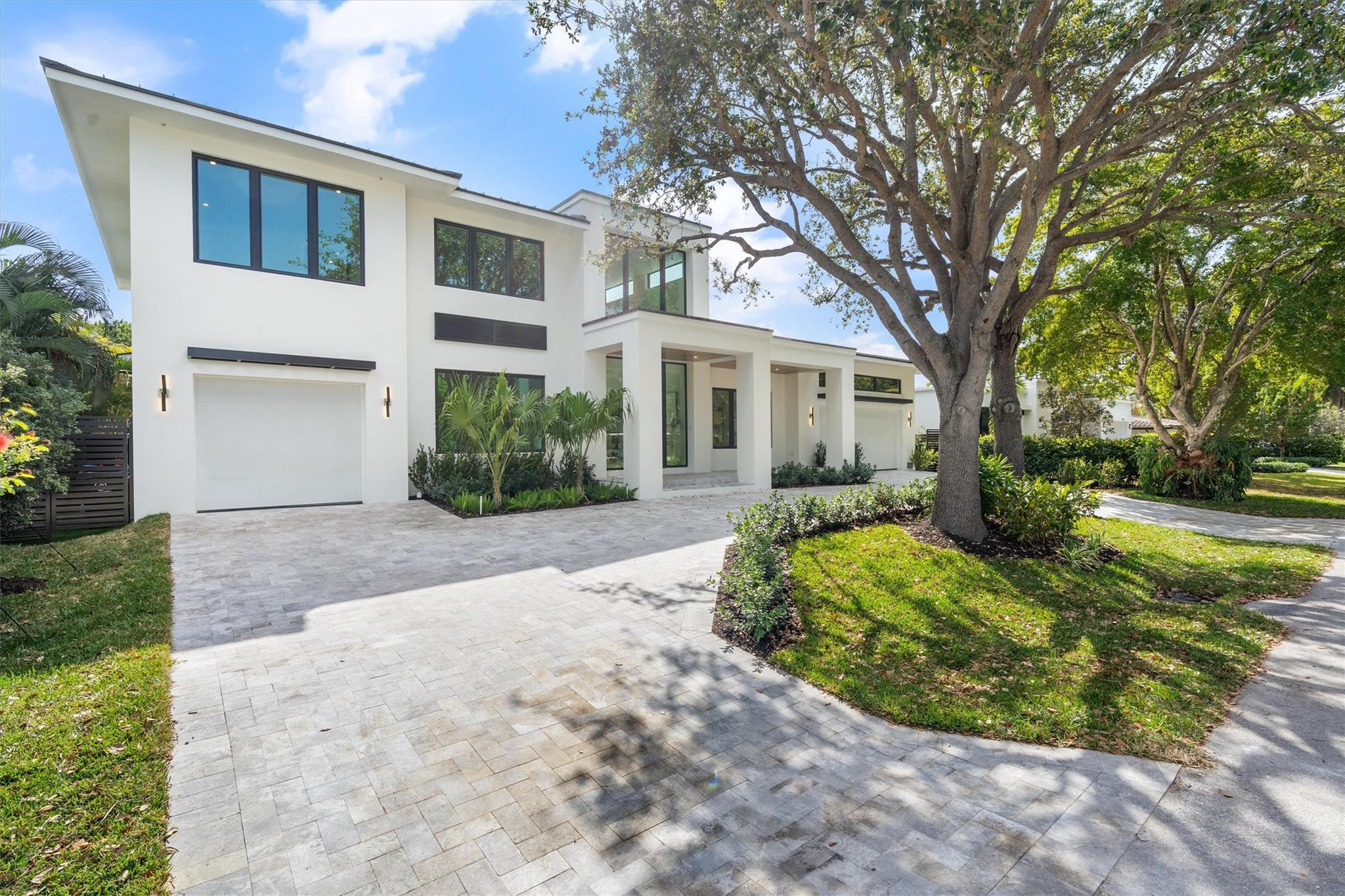One of the only courtyard-design homes in Coral Ridge, this architectural masterpiece completed in 2026 delivers true privacy bathed in incredible natural light. The layout centers on a quiet sanctuary anchored by a signature custom hardwood-and-glass staircase. Soaring ceilings set the tone, with Taj Mahal Cremo stone flowing from the island to the backsplash in a Thermador kitchen designed as the ultimate space for cooking and entertaining. The first-floor primary suite serves as a secluded retreat with a spa bath. This 4-bedroom, 4-bathroom residence includes a versatile office/gym, thoughtful dual-level laundry, and a 3-car garage. Outside, the sun-drenched courtyard features a saltwater pool and summer kitchen where indoor and outdoor living dissolve into one.