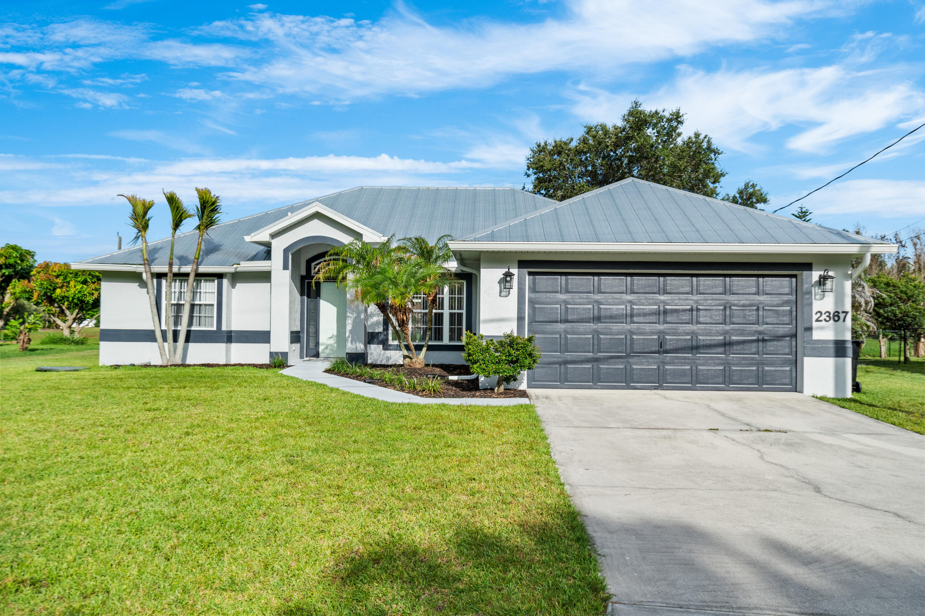 Welcome to this beautiful 3-bedroom, 2-bathroom home in the heart of Port St. Lucie, Florida! Featuring an open-concept floor plan, this home offers spacious living and seamless flow between the living, dining, and kitchen areas—perfect for entertaining and everyday living.  The kitchen is equipped with stainless steel appliances, while the home also features a durable metal roof for added peace of mind. Step outside to enjoy the screened back patio overlooking the canal, providing a relaxing outdoor retreat. The fully fenced backyard offers privacy and plenty of space for pets, play, or gardening. Additional highlights include a 2-car garage, canal-front location, and no HOA, giving you the freedom to enjoy your property without additional restrictions or fees. Conveniently located near shopping, dining, schools, parks, and major roadways, this move-in-ready Port St. Lucie home offers comfort, functionality, and Florida living at its best!