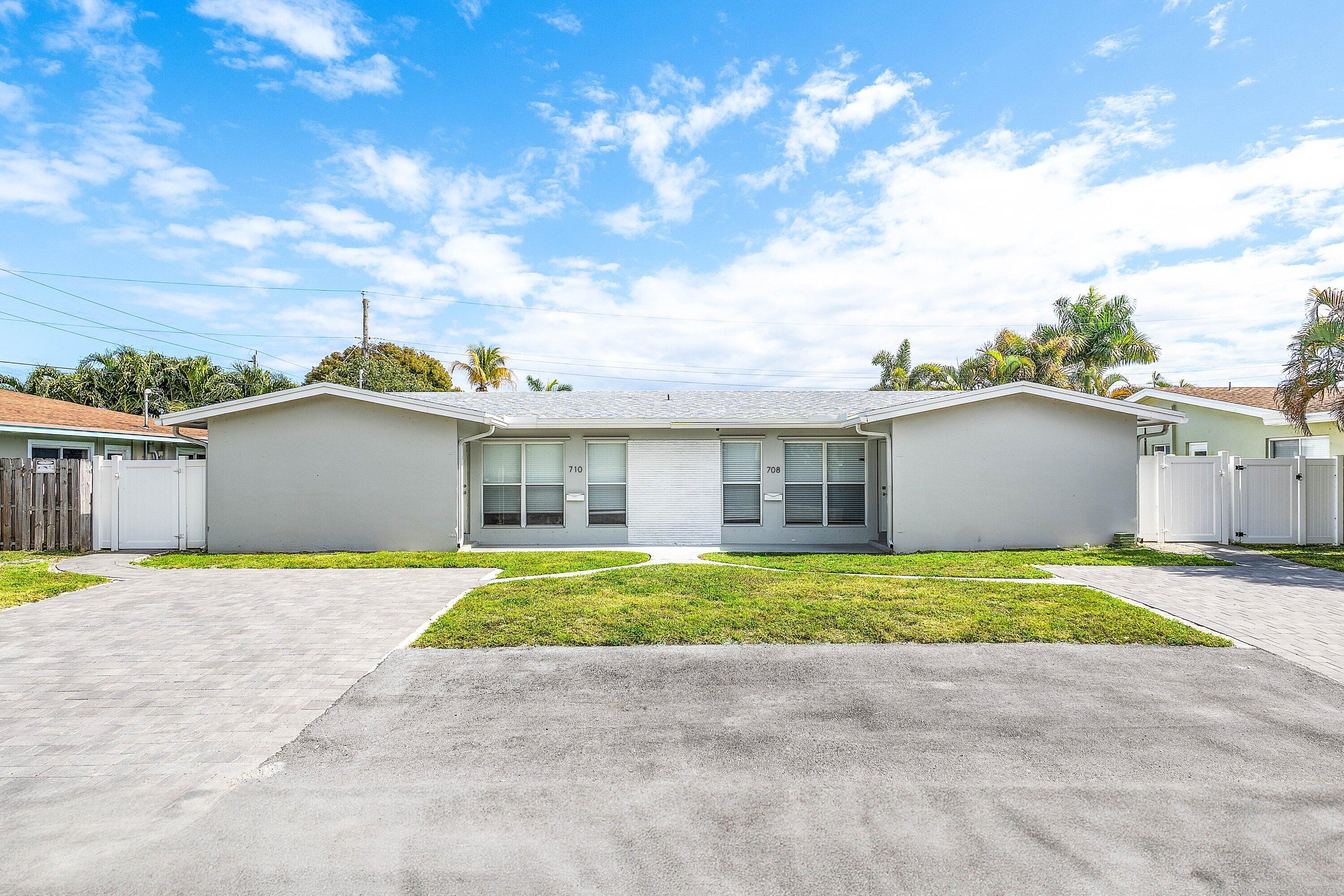 Fully renovated duplex located east of Federal Highway in Pompano Beach. This rare side-by-side property features two spacious 2BR/1BA units, each offering 1,000+ SF, private entrances, and individually fenced backyards. Both units have been updated top to bottom with modern open kitchens, quartz countertops, stainless steel appliances, tile flooring, updated bathrooms, fresh landscaping, and white PVC privacy fencing. Each unit includes a full-size washer and dryer and is separately metered. Ample driveway parking, storm protection with a mix of impact windows and shutters, and recent major improvements including a new driveway and roof. No HOA. Prime location minutes to the beach, A1A, Pompano Pier, parks, dining, shopping, and major highways. Ideal turnkey investment or to house-hack!