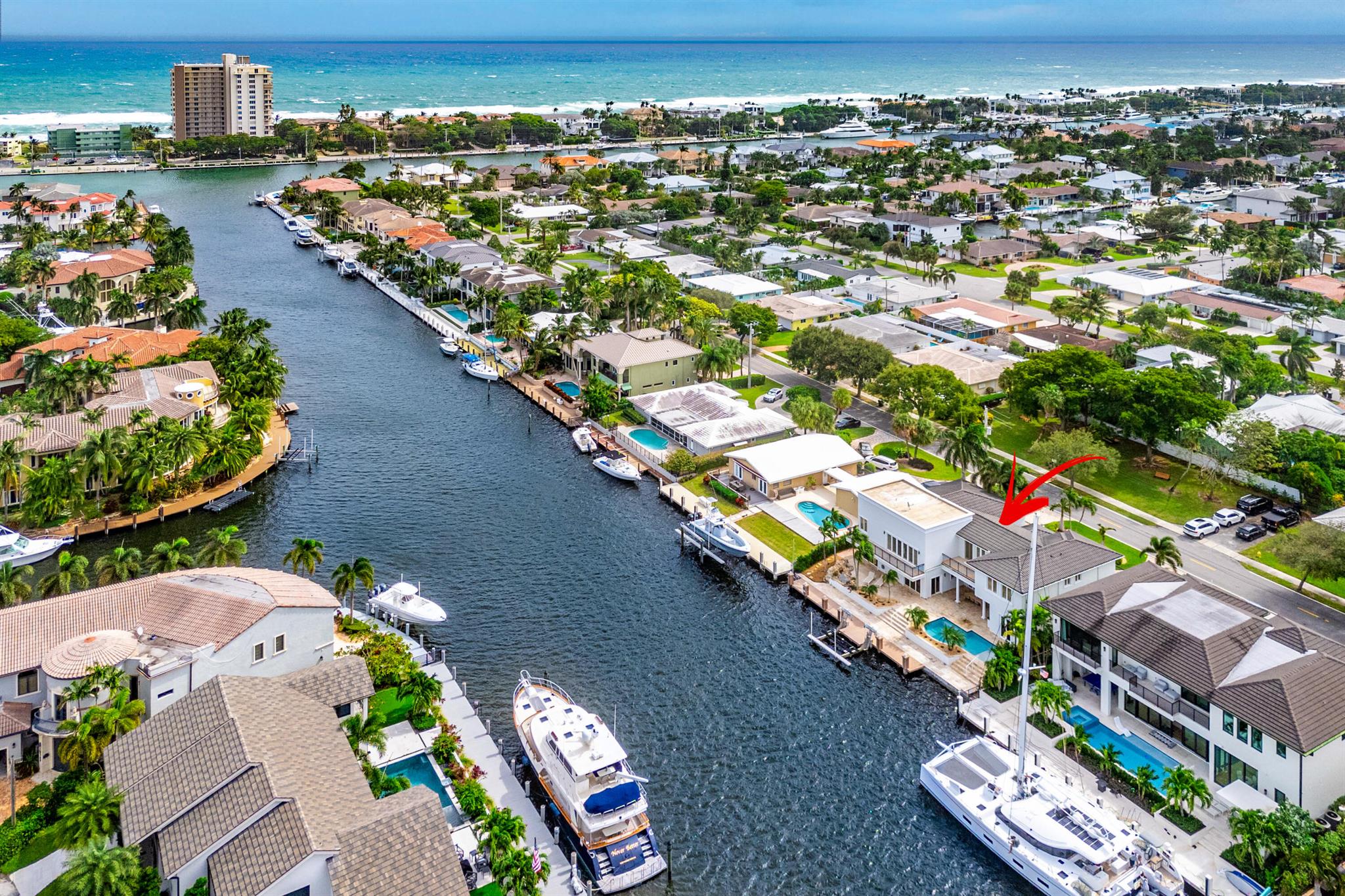 Experience unparalleled waterfront living in this stunning custom estate, perfectly situated along the expansive South Grand Canal which is 90 feet wide making it easy to navigate and turn around your vessel to 90 feet of dockage. Complete with a gated entry for added privacy. Ideal for boating enthusiasts, this estate features a full-service composite yacht dock and a 20,000 lb. boat lift, just minutes from Hillsboro Inlet for ocean access.  

Inside, you are greeted by a grand entryway with dual staircases and exquisite marble flooring. Soaring ceilings and abundant natural light illuminate the expansive gourmet kitchen and elegant living spaces. This home boasts four bedrooms, 4.5 baths, and a waterfront office/den, all radiating timeless coastal elegance. The master suite includes access to a spacious terrace overlooking the water, while the media room is ideally located between the master suite and two additional oversized bedrooms, providing the perfect setting for family game nights or movie marathons. 

Step outside the living room to discover a covered balcony and outdoor kitchen that overlook your custom heated pool, creating an entertainer's paradise. Additional highlights include a 3-bay garage, impact doors and windows, two new air conditioners, and numerous other upgrades. This property represents a rare opportunity on the South Grand Canal in Lighthouse Point. Just 15 miles from Fort Lauderdale and 35 miles from West Palm Beach, it offers the perfect blend of quiet coastal living with easy access to vibrant city life nearby.