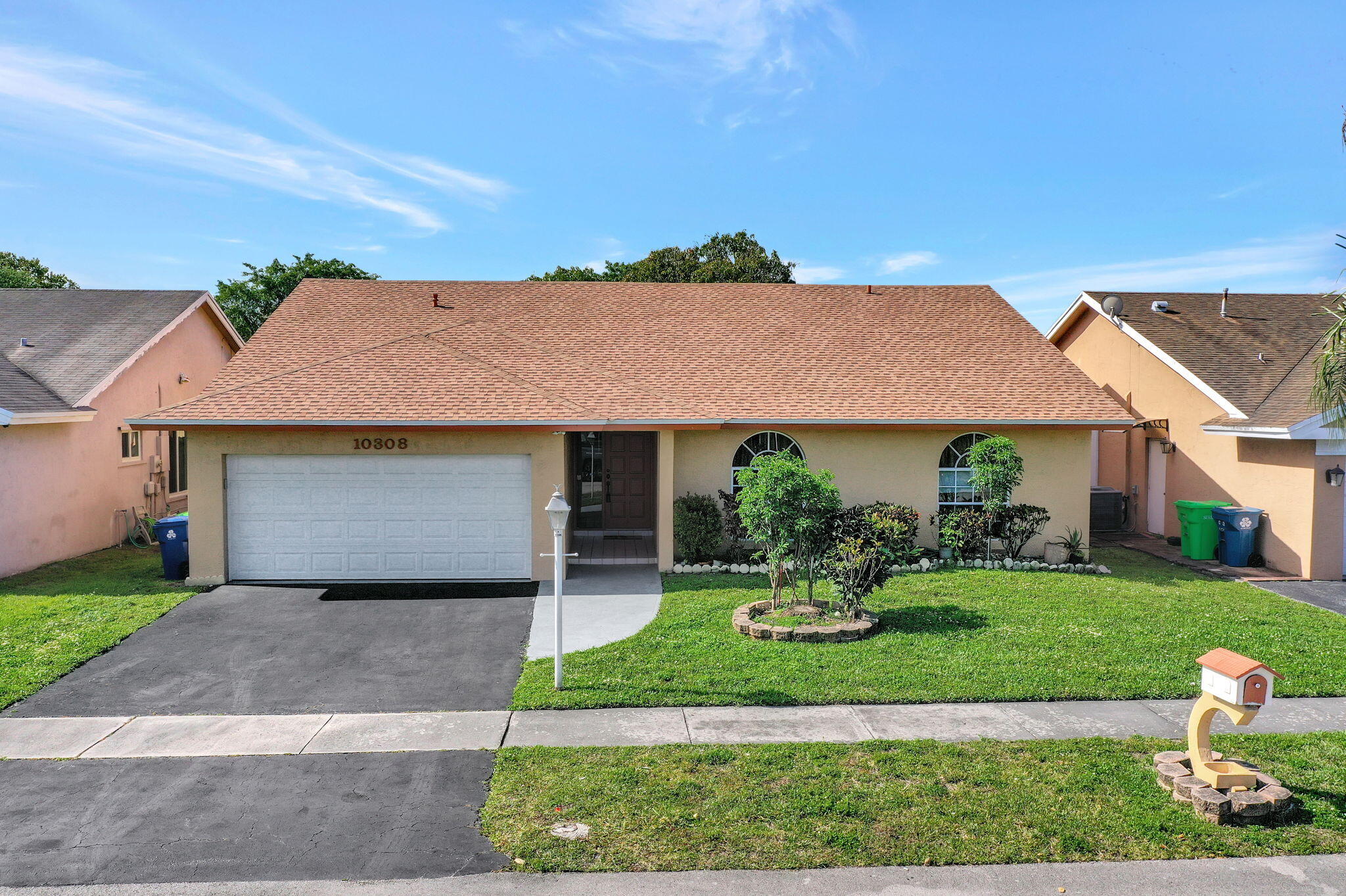 Rare Hidden Gem! This original owner purchased a 4 bedroom model from the Builder and redesigned it into a 3 bedroom w/2 extra walk in closets plus a super sized XXL patio that was structurally enclosed and can be a 4th bedroom, an office or whatever your heart desires. Over 500+ sq ft of living area added! Lots of interior storage space inside plus a 2 car garage tucked away in this 57 home community. * LOW HOA fees ($168/Q) * New Roof (2026) * New garage door (2025) * Newer A/C (2021) * Metal storm shutters * New plush carpeting for your toes in the  bedrooms * Spacious kitchen with granite counters, snack counter, stainless steel appliances, pantry and vaulted ceilings galore! Tis the season for Mangos...just step in your backyard!