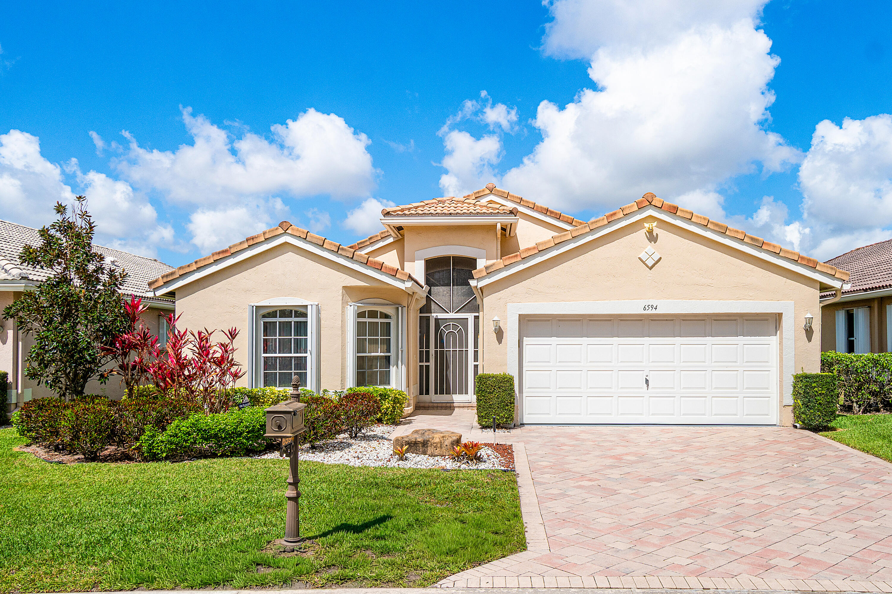 Enjoy breathtaking lake views from this sparkling clean and meticulously maintained home. A brand-new 2026 roof offers peace of mind, while the 264 sq ft expansive, air-conditioned sunroom/lanai—complete with a brand-new mini split—creates the perfect space to relax and take in the serene waterfront setting year-round. Inside, the home is light, bright, and beautifully updated with neutral paint, extensive high-hat lighting, and no popcorn ceilings. New carpeting in all bedrooms adds comfort, while the main living areas flow effortlessly toward the oversized enclosed lanai, creating additional air-conditioned living space ideal for entertaining or quiet mornings overlooking the lake. The kitchen and laundry areas are equipped with a new washer and dryer, and modern conveniences  include a Nest smart thermostat for the A/C (2019) and a hot water heater from 2016. The home is also protected with accordion shutters for added security and storm protection. The oversized two-car garage offers exceptional functionality with a slop sink and new garage door opener, providing plenty of room for storage, hobbies, or additional workspace. Immaculate, move-in ready, and thoughtfully maintained throughout, this beautiful lakefront property is available furnished, unfurnished, or with furniture negotiable, making it easy to start enjoying the Florida lifestyle immediately.