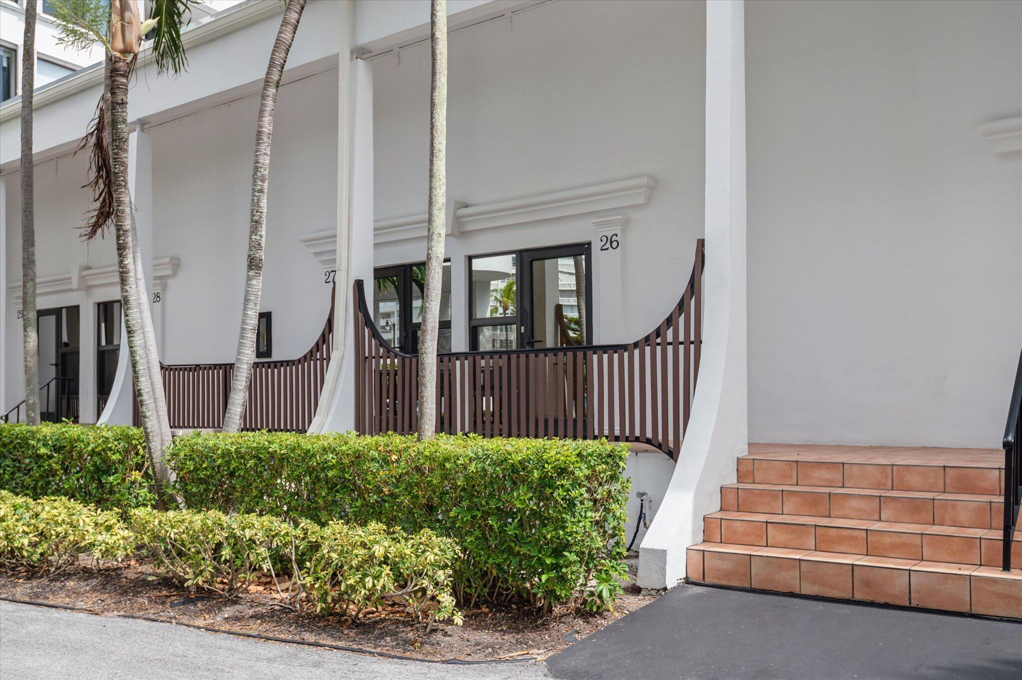 Welcome to Mayfair House in South Palm Beach, where coastal living meets convenience. This beautifully renovated 1 bedroom, 2 full bathroom townhome offers 922 sq ft of thoughtfully designed living space with dramatic volume ceilings and an open, inviting floor plan. The residence features a spacious living/dining area, an updated open concept kitchen, and impact windows and doors that open to a private lanai overlooking the lagoon and tropical grounds. The versatile layout includes two full bathrooms, a separate laundry room, and an upstairs primary suite with generous closet space. Enjoy year round Florida living with private deeded beach access directly across the street, complete with a beachfront sundeck, gazebo, and BBQ area. Mayfair House residents enjoy a variety of amenities,  including two heated pools, a fitness center, sauna, community room, observation deck, bike storage, car wash area, 24-hour doorman service, and assigned parking conveniently located just outside your door. Ideally located within walking distance to shops, restaurants, and the renowned Eau Palm Beach Resort & Spa, this property is perfect as a primary residence, seasonal getaway, or investment opportunity. Experience the best of South Palm Beach living just steps from the beach.