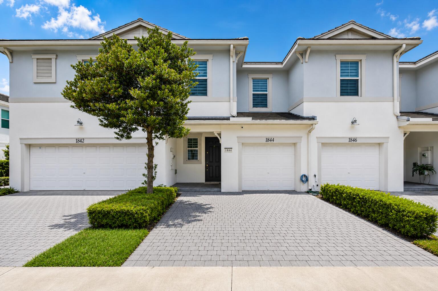 Welcome to 1844 Sandpiper Pointe Place, perfectly positioned on one of the most desirable streets in the sought-after gated community of Sandpiper Pointe. Built in 2020, this meticulously maintained, extensively upgraded and smart home technology,  3-bedroom, 2.5-bath townhome offers the perfect blend of modern style, comfort, and convenience. Complete with a spacious loft, one-car garage with a Tesla EV charger, and countless smart-home features, this move-in-ready home truly stands out.  Step inside to a bright, open-concept layout filled with natural light. The beautifully designed kitchen is the heart of the home, featuring quartz countertops, rich wood cabinetry, stainless steel Samsung appliances (2022),  a mosaic subway tile backsplash, smart under-cabinet lighting with customizable colors, and generous prep space perfect for both everyday living and entertaining.  Upstairs, you'll find three spacious bedrooms along with a versatile loft that can easily serve as a home office, playroom, fitness area, or media room. The primary suite is a private retreat featuring a large walk-in closet and a spa-inspired ensuite bath with dual vanities, a frameless glass shower, and a luxurious rainfall shower head. The spacious secondary bathroom also features dual vanities, providing added functionality for family and guests. A generously sized laundry room with additional storage adds even more convenience.  This home has been thoughtfully updated with premium improvements, including: Brand-new Rheem A/C (2026) Whole-home water filtration and Rheem water softener (2025) Style Selections Waterproof Luxury Vinyl Plank Flooring with pet protection throughout the second floor (2025) STAINMASTER PetProtect Carpeting (2025) on staircase, Tile flooring throughout the first floor, Tesla EV charging station, Nest thermostat, Tapo doorbell and cameras, Ring security system, Yale smart locks, Zigbee smart lighting, and automatic window shades, fully fenced backyard with privacy fencing, Impact-resistant windows and doors for added security and peace of mind. Enjoy a low HOA, which includes lawn care, cable, internet, making for an easy, low-maintenance lifestyle. With no rental restrictions, this property also presents an excellent opportunity for investors or owners seeking flexibility.  Sandpiper Pointe residents enjoy resort-style amenities, including a community pool, fitness center, and playground, all within a gated community. Ideally located just minutes from shopping, dining, major highways, entertainment, and South Florida's beautiful beaches, this home offers exceptional convenience.  With designer finishes, extensive upgrades, smart-home technology, and an unbeatable location on one of Sandpiper Pointe's most desirable streets, 1844 Sandpiper Pointe Place is a rare opportunity you won't want to miss.