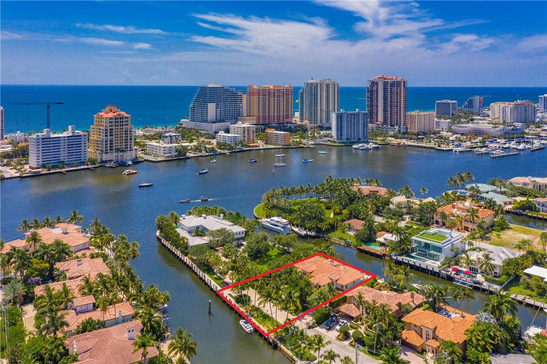 Exceptional Seven Isles estate on a PRIVATE GATED STREET w/a total of 203' of deep water frontage on 2 canals & dockage for multiple yachts. Just 1 house from the Intracoastal point! Features include water views from every bedroom, curved marble & wrought iron staircase, great room w/20' ceilings & magnificent 2-story stone fireplace, master suite w/dual baths, morning bar & sitting room. Theater, gym, elevator. Lutron lighting/smart home system. Perfect for year-round outdoor entertaining w/tumbled marble patio, vast covered area, outdoor summer kitchen & heated pool. Guardhouse at the Seven Isles entrance w/high res camera which records license plates of each vehicle entering & leaving. Walk to the beach, Las Olas dining & shopping!!