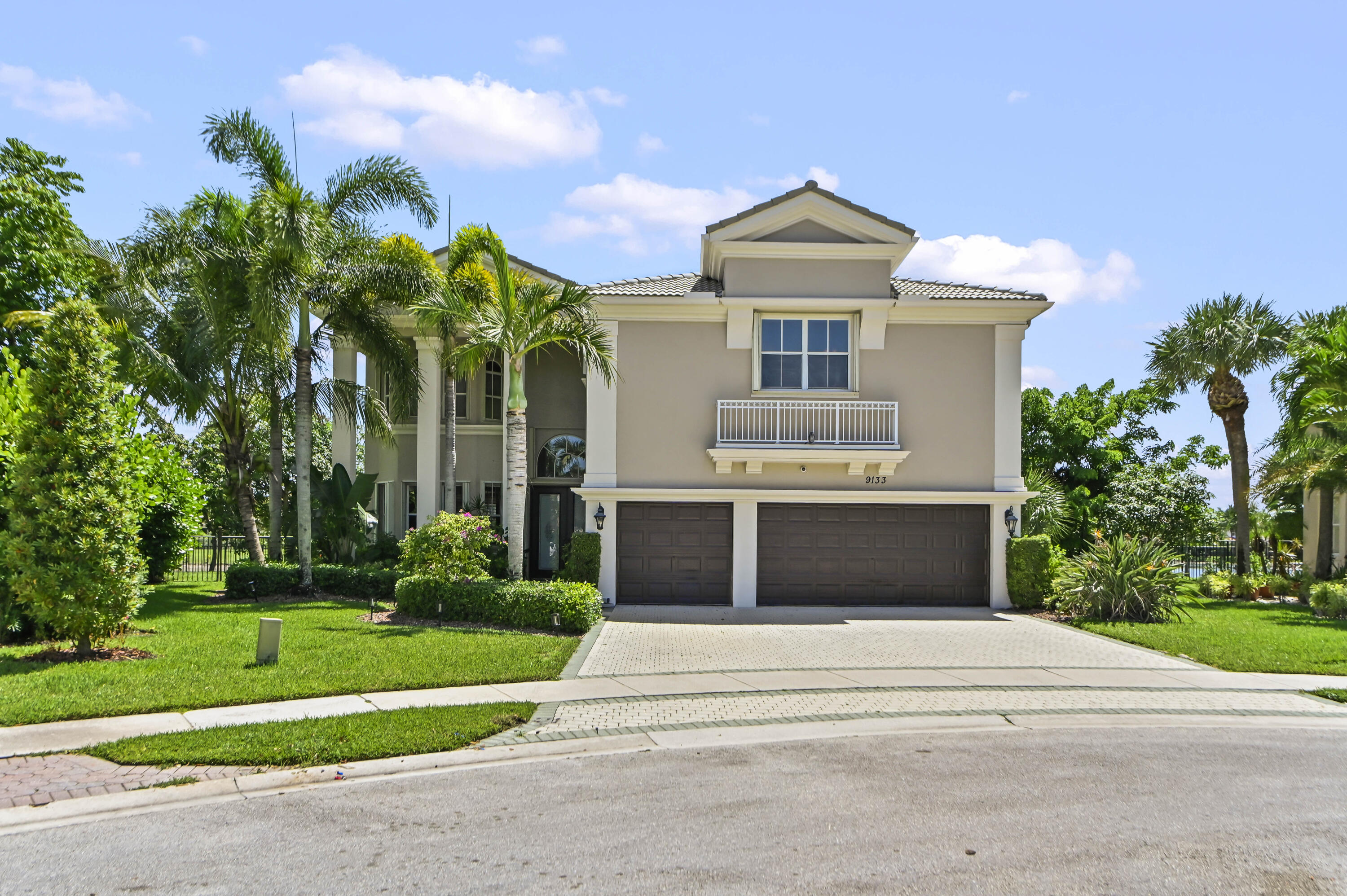 Welcome to this exceptional Sienna Grande model in the prestigious, gated Olympia community of Wellington, Florida. Lovingly maintained by its original owners, this impressive two-story pool & waterfront residence offers 3,963 square feet of thoughtfully designed living space, featuring six spacious bedrooms, four full bathrooms, and a three-car garage.  Designed for both comfort and functionality, the home includes a convenient first-floor bedroom, while the upstairs secondary bedrooms are connected by a Jack-and-Jill bathroom layout.   The expansive primary suite serves as a private retreat, offering a generous sitting area, custom-built cabinetry, a large walk-in closet, an ensuite bathroom, and direct access to a private balcony overlooking the serene lake, sparkling pool, and beautifully landscaped gardens.  Throughout the home, plantation and accordion shutters provide both timeless style and added storm protection, extending to all windows and the front and rear doors. Recent updates include new AC units installed in 2026, a freshly painted exterior, and refreshed interior paint in the three secondary bedrooms, enhancing the home's move-in-ready appeal.  Outdoor living is equally impressive, featuring an expansive covered patio that spans the full length of the home, creating the perfect setting for entertaining or relaxing while enjoying peaceful waterfront views. The lush backyard is enhanced by mature exotic fruit trees, including mango, avocado, and sapodilla, adding both beauty and charm to the property.  Combining spacious living, thoughtful upgrades, & scenic views, this meticulously cared-for residence presents an outstanding opportunity to enjoy the best of Wellington living including resort amenities including clubhouse, fitness center, pool, tennis courts, pickle ball, basketball courts, scenic walking paths and the security of a sought-after gated community -- all minutes from top-rated schools, shopping, and Wellington's world-renowned equestrian horse show.