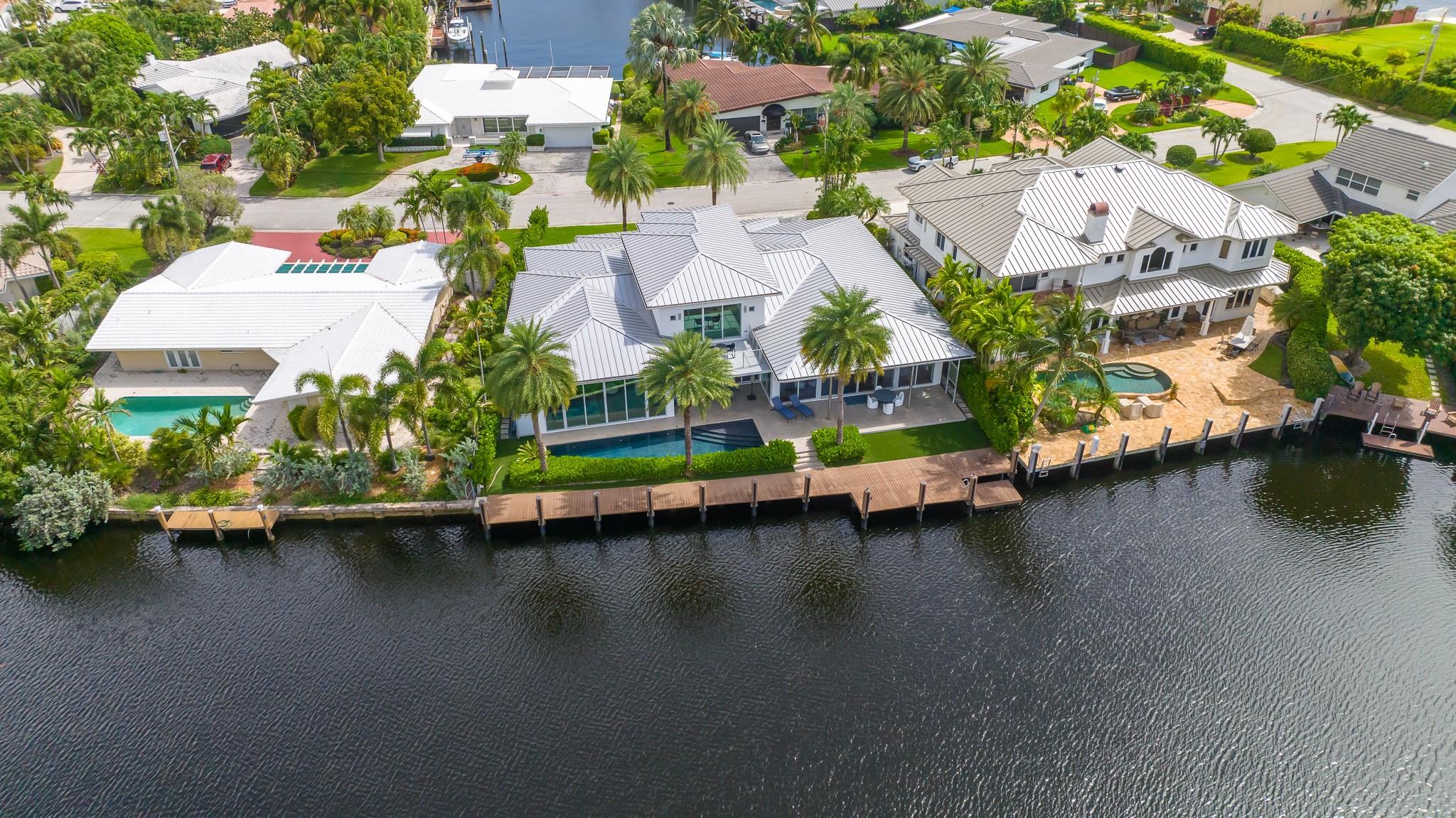 Welcome to the Landings a True boater's community. Built in 2014 & designed by Robert Tuthill. This Contemporary Waterfront 4 bed 4.5 bath 3-car garage pool home features the ultimate Open floor plan w/ 12-20ft ceilings. Split bedrooms, large master w/ spectacular water views. Home Situated on a wide water way w/ 102ft of dockage, one inlet from the intracoastal. Home has high energy efficient impact windows & doors, two 5 ton 18 seer ac units, Iclyene foam insulation in the attic, aluminum roof, 2 gas tankless hot water heaters, engineered wood flooring. Kitchen features Miele appliances, European cabinetry, induction cooktop w/gas burner, Double refrigerator & freezer, steamer, wine cooler, wet bar with kitchen Island that seats six, Experience indoor outdoor living at it's Finest !!! Floor plan, Survey, Seawall ordinance Fact sheet
