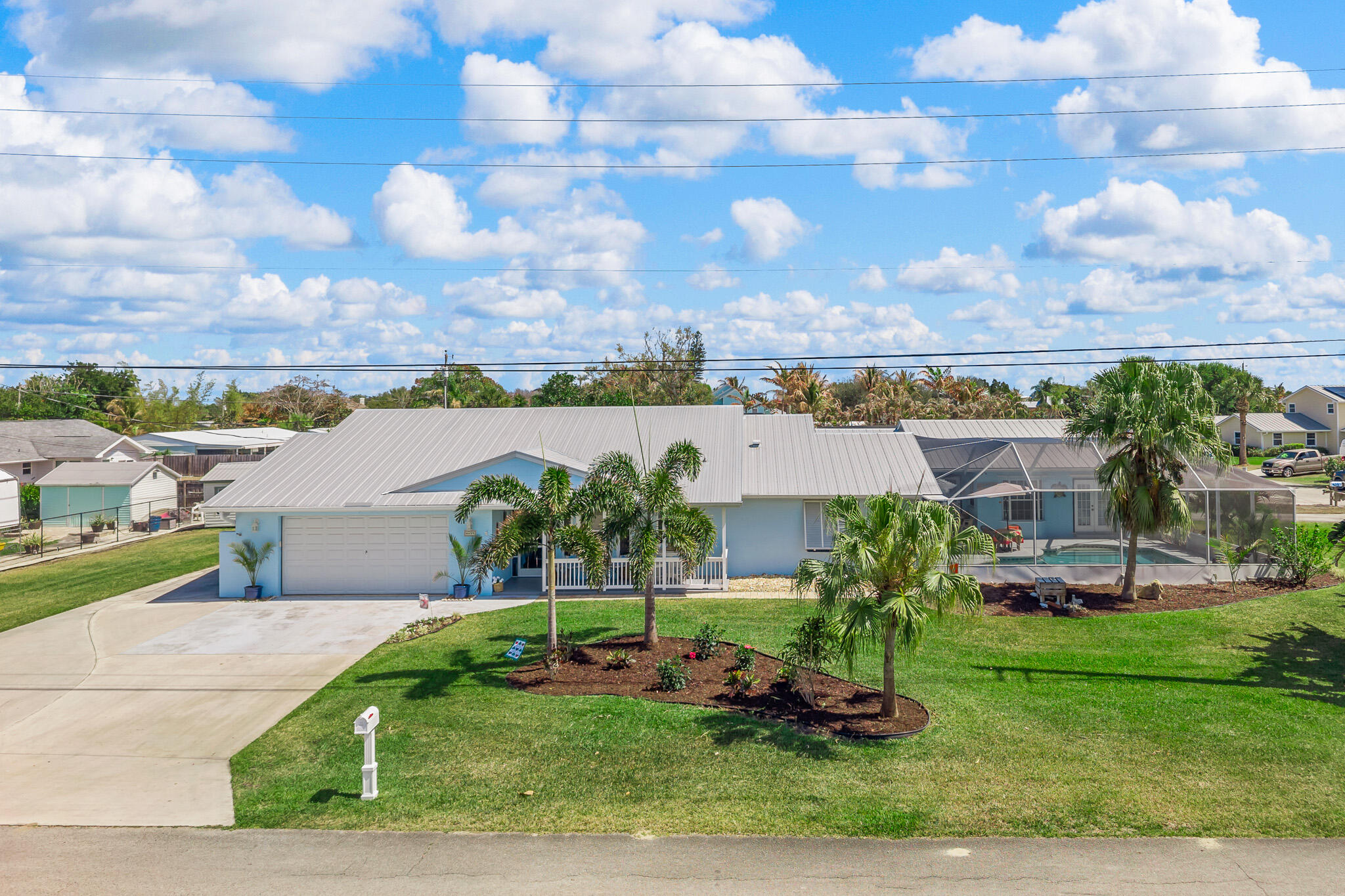 Situated on a spacious corner lot in Stuart's desirable Rocky Point community, this unique property features a 3BR/2BA main home plus a separate 2BR/2BA guest house with private laundry. The expansive floor plan includes a dedicated office, generous living spaces, and a bright Florida room overlooking the screen-enclosed pool and fenced backyard. Enjoy deeded rights to the Pioneer Club with access to a private boat ramp and the Intracoastal Waterway. A rare opportunity to enjoy flexible living and the Florida boating lifestyle just minutes from downtown Stuart, waterfront dining, and beaches.