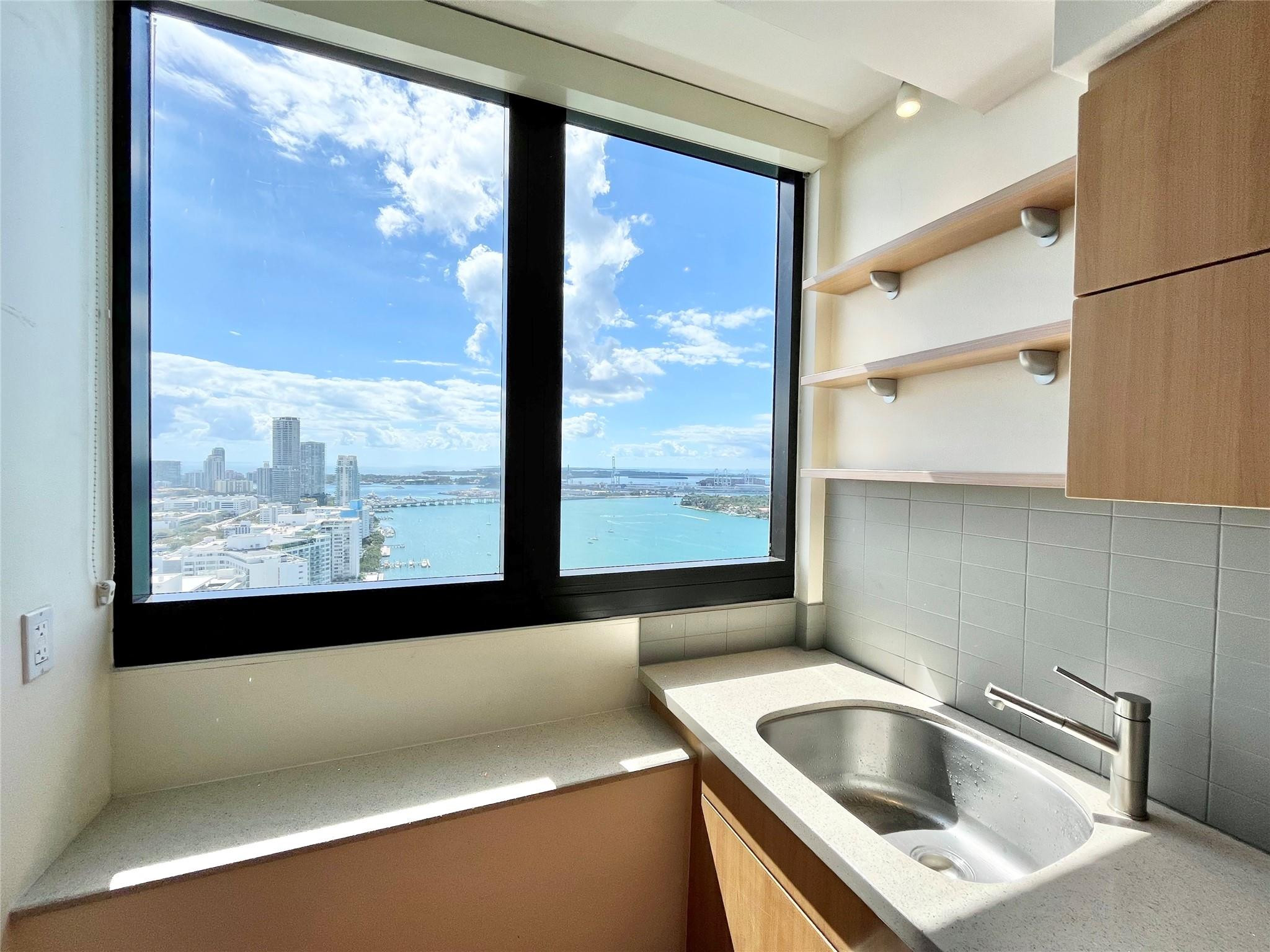 'Waverly at South Beach' Condominium, high floor fully renovated designer unit.  Views, views!  Panoramic unobstructed 34th-floor views of Biscayne Bay, Downtown Miami, Art Deco District & the ocean.  Full renovation: custom German cabinets, quartz kitchen counter, stnls. appliances, custom window shades, full size wsh/dry.  Primary Bath: Italian stone, shower/tub w/jets, custom vanity/sink.  Guest Bath: Italian stone, custom mosaic vanity/sink, glass shower enclosure.  Beautiful wood floors in unit, stone in bathrooms.  Double doors to 2nd Bdrm.-open to Liv. Rm.  Walk to Lincoln Rd.  *Full service bldg. w/24Hr Valet/Front Desk, Gym, Heated Pool, Tennis Ct., Sand Volleyball Ct., BBQs, 2 pkg. spots (1 valet).*  Brand new impact glass windows & doors installed 2025. Rentals can be 6-12 mos.