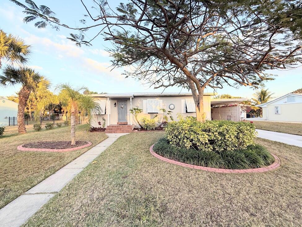 Experience the best of island living in this charming fully furnished 3-bedroom, 1-bath beach cottage just a short walk—only a few blocks—from the Atlantic Ocean, Fort Pierce Inlet, Jetty Park, waterfront restaurants, and local favorites like Archie's. Situated on an oversized lot, this CBS home offers a warm coastal feel with original wood flooring, an updated kitchen, a spacious living area, and a bright enclosed sunroom overlooking the backyard—perfect for relaxing after a day at the beach. Enjoy Florida living year-round from the large screened patio, while the covered carport provides convenient parking and additional storage. Bahama shutters add to the home's coastal character, and the generous backyard offers plenty of room to entertain or even add a future pool.