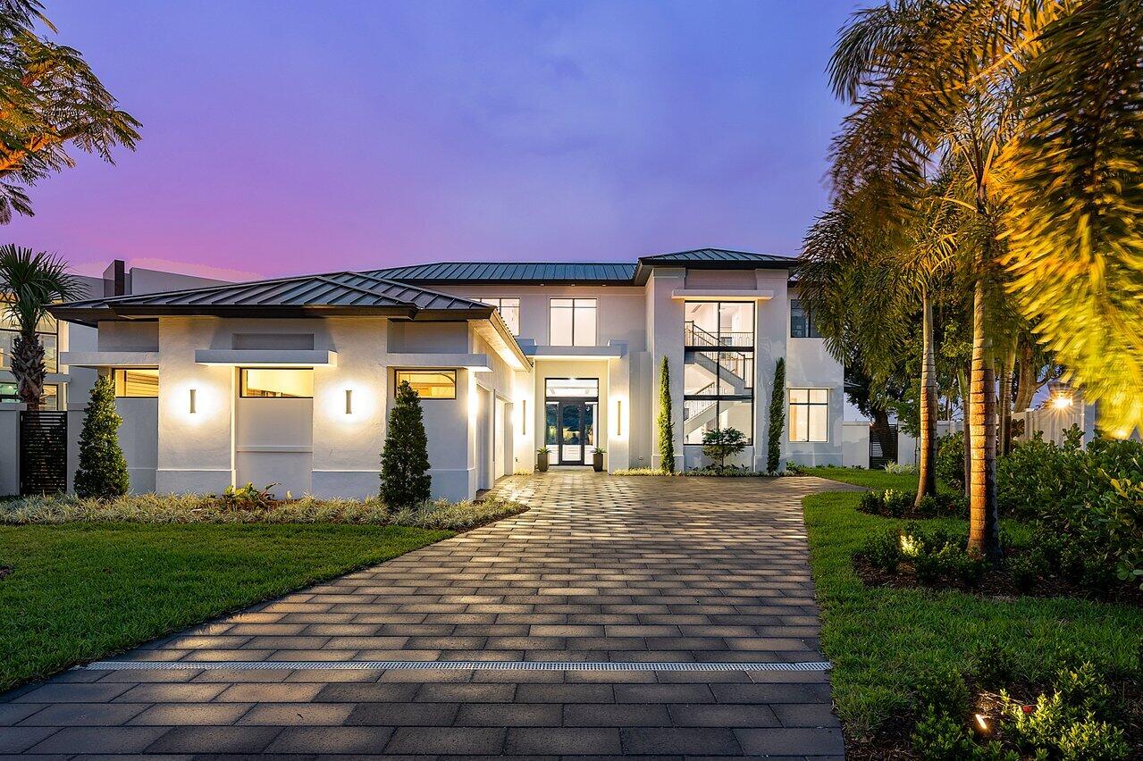 From panoramic lake views and a private beachfront to the impeccable craftsmanship that permeates every facet of its composition, the waterfront estate at 1524 Lake Drive blends every aspect of South Florida luxury to create an idyllic residence without equal. Comprising 4,987 total sq ft., this gorgeous two-story new construction from Marc Julien Homes has been engineered to the specifications of ideal South Florida living, from its impeccable location down to the smallest discernible details. Nestled on a rare north-facing corner lot with sweeping views of Lake Ida in one of Delray Beach's most alluring neighborhoods, this home integrates all the comforts of a contemporary residence without sacrificing the organic splendor of waterfront living in South Florida. Crafted with a modern architectural style and enhanced further by its grand wood ceilings and 9-foot hidden-hinge impact glass doors and broad windows, 1524 Lake Drive perfectly blends the serenity of a lakefront vacation home with the functionality of a primary residence in a thriving metropolitan area.  

 From the moment one enters through the foyer, they are greeted by full-length glass doors that offer abundant natural light and blend the open great room and kitchen/dining spaces with the exquisite outdoor area. Once outside, a backyard oasis beckons, with amenities including a 14x30' heated saltwater pool with sunshelf and spa, and a loggia with an Urban Bonfire summer kitchen with marine-grade aluminum cabinets and an Edgestar 36" grill, which are second only to the sweeping lake views and private beachfront.   

After returning inside from taking in the view, perspective shifts back to the home's indoor comforts. The home's impressive kitchen bears countless culinary conveniences, from its island and bar seating to its cutting-edge appliances, which include a 36" Thermador refrigerator, 30" Thermador upright freezer, top-of-the-line 48" Thermador dual fuel gas range with matching wall-mounted range hood, 24" Thermador Microdrawer Microwave, and Thermador 5-program dishwasher. Aesthetic features elevate the space beyond the impressive sights of its state-of-the-art appliances, with bespoke custom cabinetry in dual tones, a walk-in pantry, and dazzling dove white matte porcelain flooring. Just a few steps away, an additional wet bar off the kitchen is perfect for entertaining, and includes super white pure polished quartz countertops, Quarzo porcelain backsplash, a Moen bar faucet in brushed gold, stainless steel Kohler undermount bar sink, and a Signature 24" wine refrigerator with Wine Cave technology.  

The kitchen leads into either the elegant home office or the great room and its palatial wood ceilings, then eventually to the primary suite. Steeped in elegance and functionality, the primary suite includes engineered oak wood floors and ceiling detail, spacious his-and-hers closets, and 9' sliding doors that lead directly to the backyard. The primary bathroom is superb in and of itself, boasting dual vanities and water closets, Cemento white honed porcelain floors, taupe polished porcelain shower walls, Glazzio Nubian tapestry glass tile shower floors, super white pure polished quartz countertops and backsplash, and a 70-inch freestanding Rebecca tub.  

Upstairs, a sizable loft space blends the functionality of additional gathering space with the delight of all of its possibilities, including its sliding doors that access the second-floor balcony for additional space to relax with guests. Its communal space ties together a level that houses the home's three other bedrooms, each of which has its own ensuite bathroom and matches the artful craftsmanship of the primary living spaces.  

This home incorporates features throughout that are on the vanguard of efficient, sustainable Florida living, including advanced insulation, impact doors and windows, leading security integration, automated irrigation in outdoor spaces, and much more. Additional amenities include a 2-car garage with hurricane impact, double steel insulated doors and EV connection, energy-efficient Icynene spray foam insulation, built-in speakers throughout, Control 4 smart home automation and lighting control, a security system with alarm contacts on all windows and doors, and even more optional add-ons.  

Known throughout South Florida for its successes in contemporary living, Marc Julien Homes operates with the mission statement "committed to perfection." With the stunning residence at 1524 Lake Drive, they have achieved and surpassed their goal.