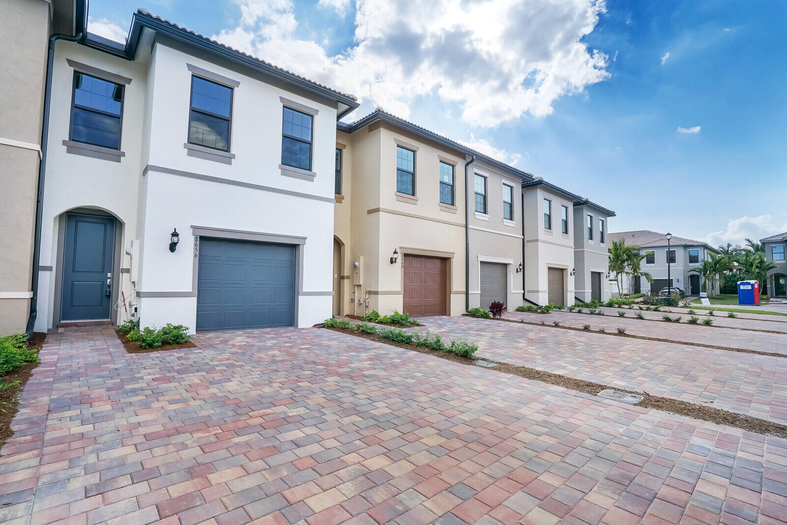 Welcome to this better-than-new townhouse offering the perfect blend of style, comfort, and energy efficiency. Built in 2023, this beautifully upgraded home features 3 spacious bedrooms, 2.5 bathrooms, and a thoughtfully designed open-concept floor plan. The first floor showcases tile flooring throughout, while plush carpeting adds warmth to the upstairs living spaces.  The stunning kitchen is the heart of the home, complete with a large center island, Quartz countertops, stainless steel appliances, a designer tile backsplash, and upgraded cabinetry that continues throughout the bathrooms. A spacious one-car garage, private patio, and full-size washer and dryer add everyday convenience.  Designed with efficiency in mind, this home includes hurricane impact windows, LED lighting throughout,