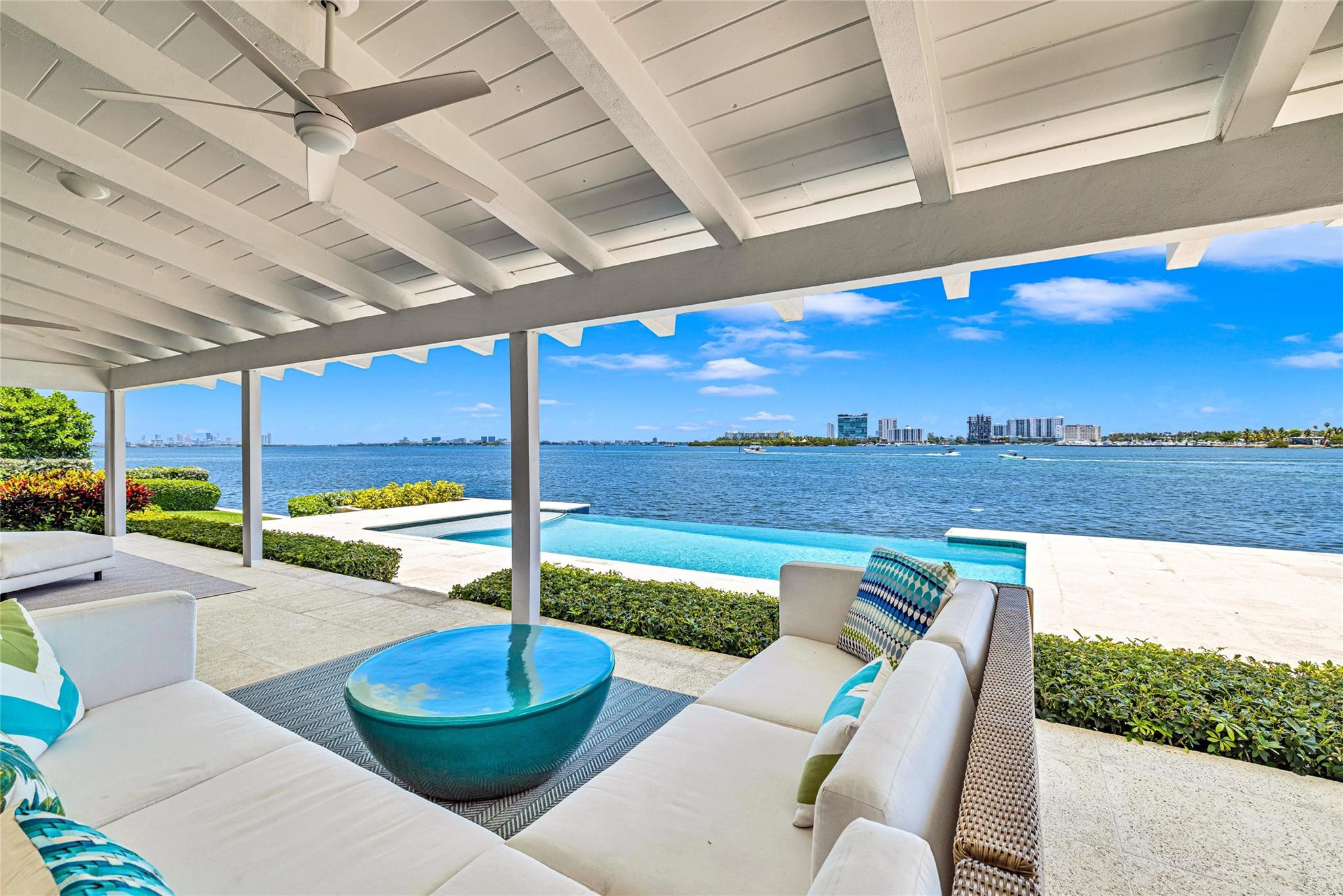 PRIME BAYFRONT LIVING in this contemporary 5,768 SF residence on a gated 27,000 SF Southeast Point Lot with 285 FT of premium waterfrontage - 150 FT directly on Biscayne Bay plus 135 FT of protected side canal dockage with dock & boat lifts. Wide open bay views from every room, skylit interiors, and seamless indoor-outdoor flow to a covered porch, infinity edge pool & expansive terrace. The 1,240 SF primary retreat and three en-suite guest rooms each offer private outdoor access plus there is an office and a fifth en-suite bedroom. Quiet cul-de-sac location with quick access to top schools, major venues, the Design District, beaches, and the airport. A rare waterfront estate offering protected dockage and the kind of long term value only a premier Miami shoreline can deliver. Biscayne Bay frontage | Impact windows & Sliders | Limestone and 24" Porcelain tile floors | Primary Bathroom - Wet room, double sinks | Bedroom #2 (also possible primary) Bathroom Wet room, double sinks | Outdoor cabana full bathroom with shower | Pool decking 1500 SF | Alarm System | 2006 Roof Concrete tile gable roof | 3 HVAC units | Two 175 AMP GE Main Breakers | 200 AMP Sieman Main disconnect on Exterior | Outdoor Storage room | 33 ft dock | Two 10,000 lb boat lifts | Crawl Space access for approximately 1/2 of the house | Room for expansion | One of the two cul-de-sac point lots (SE point a total of two lots 19,375 SF + 7623 SF= 27,000 SF